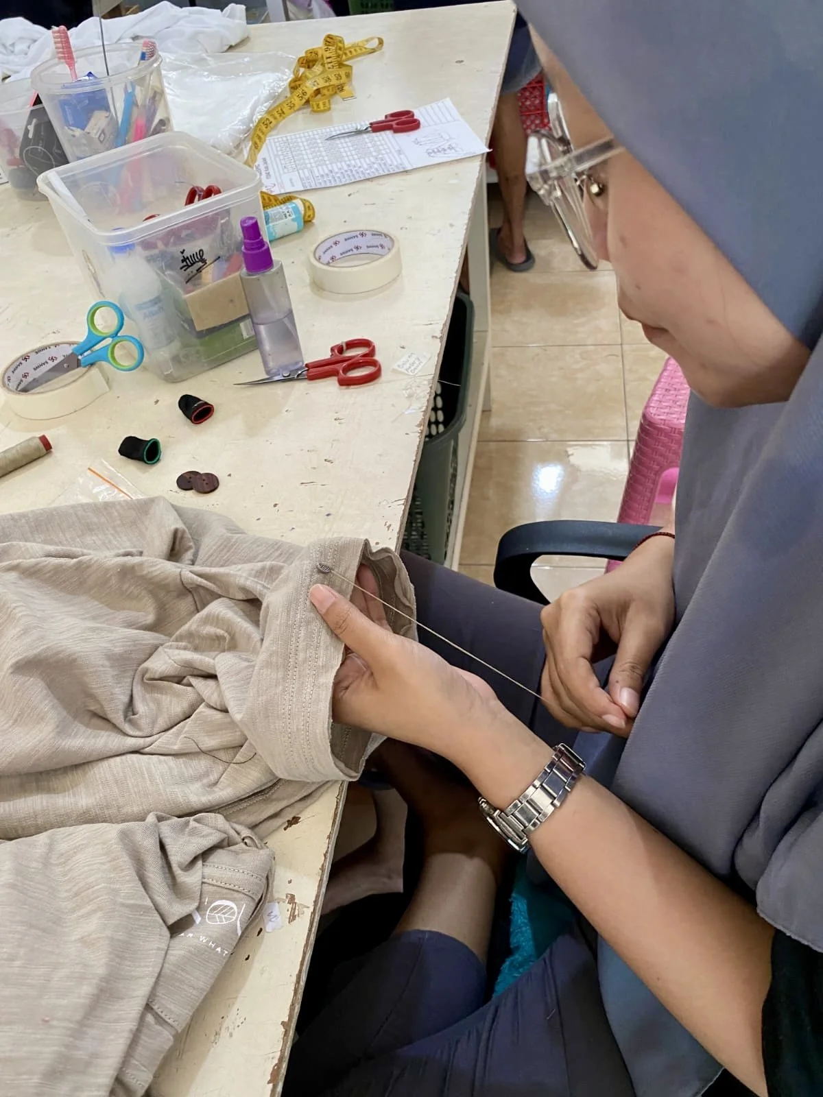 Hand-finishing the hem of a natural-fibre garment, Nousa Concept Bali