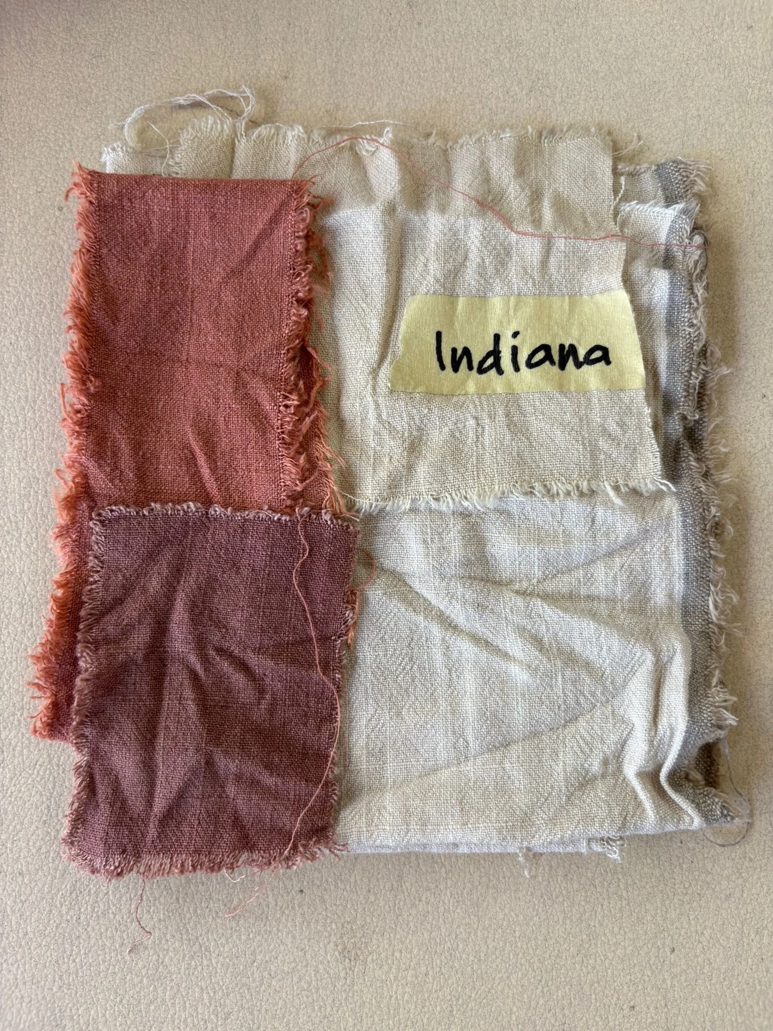 Hand-dyed natural fibre swatches in terracotta tones with handwritten colour label, Nousa Concept