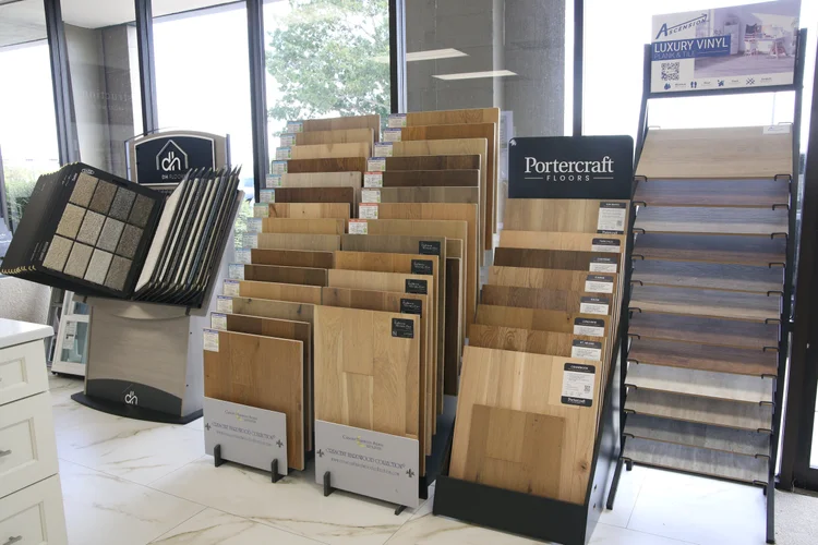Hardwood planks and luxury vinyl flooring samples on display stands