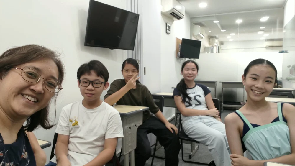 Upper primary students with their teacher in a small-group class at KnowledgeTrail, Upper Thomson