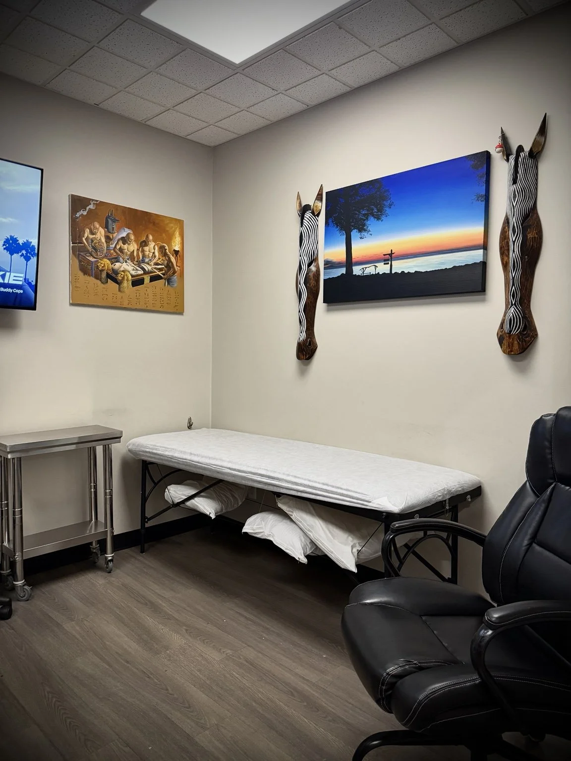 Tattoo bed, client chair and artwork inside Lakeside Tattoos in Belle River