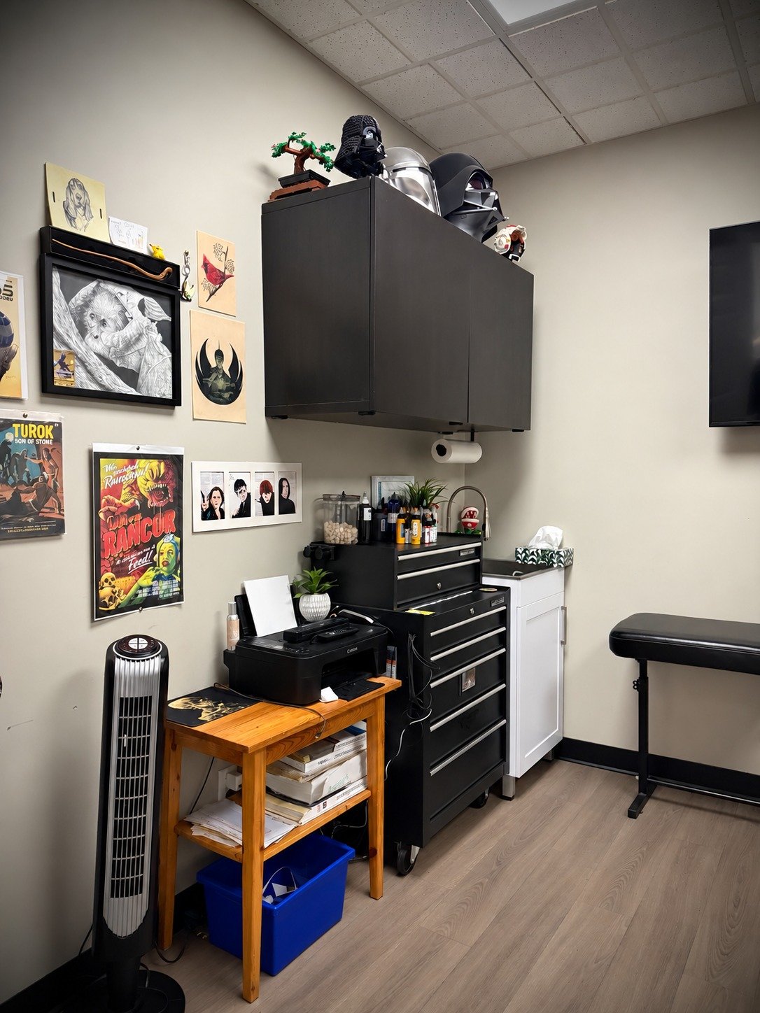 Chris Kennedy’s tattoo workstation and art wall at Lakeside Tattoos