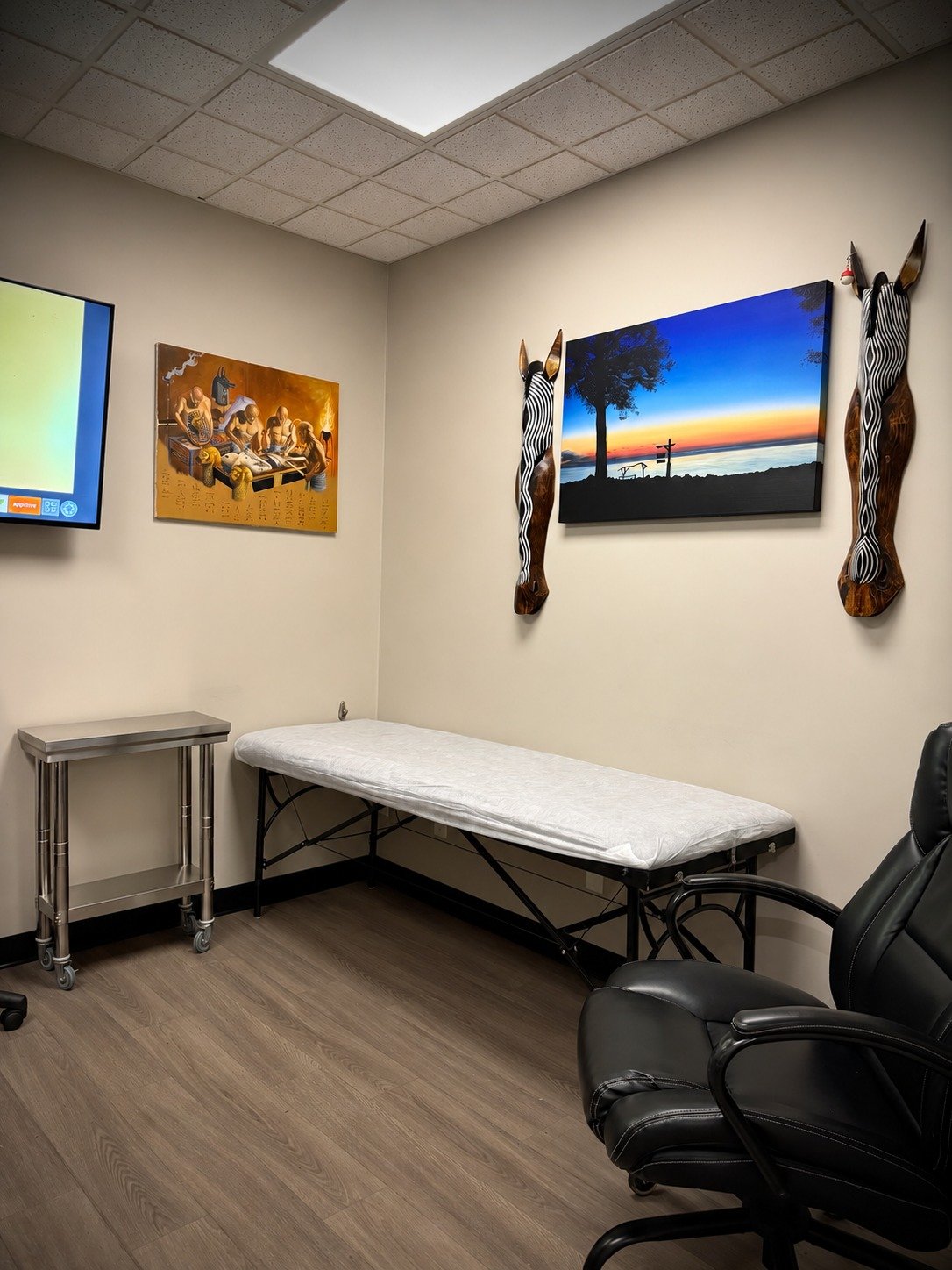Tattoo bed, client chair and artwork inside Lakeside Tattoos in Belle River