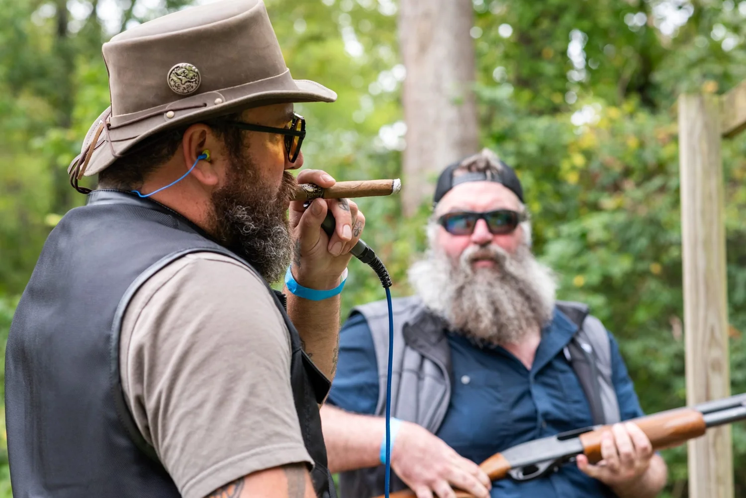 Two shooters take a cigar break between stations