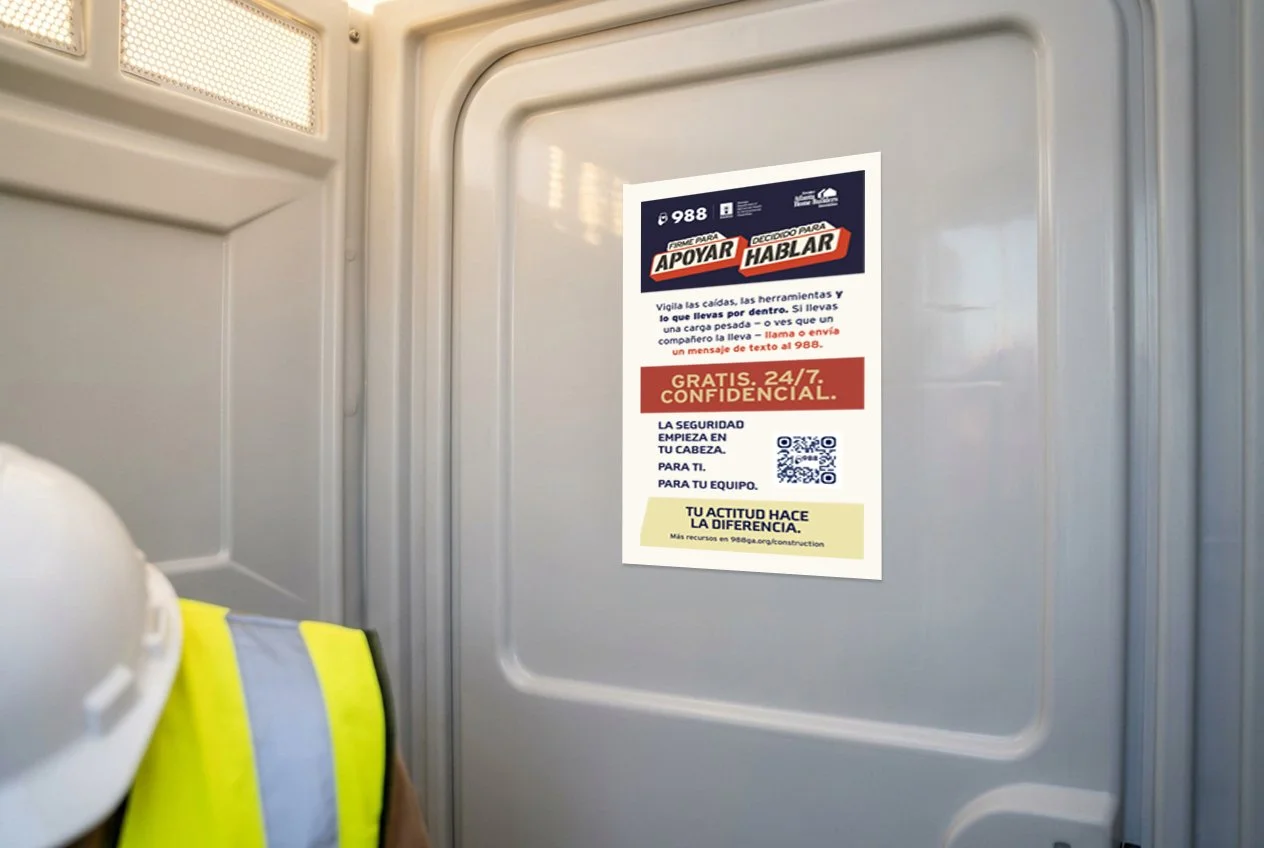 988 Spanish-language decal mounted inside a jobsite porta-potty door