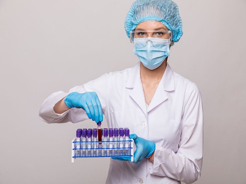 a-phlebotomist-carefully-present-a--rack-of-purple-top-tubes