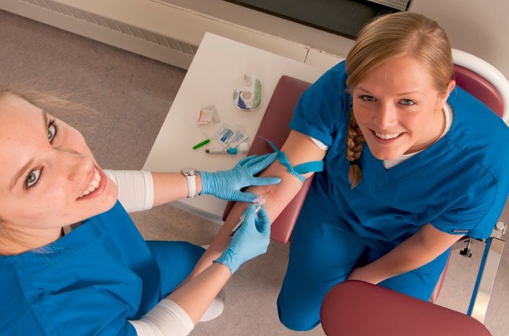 a-phlebtomist-and-a-happy-patient-looking-up-to-the-camera