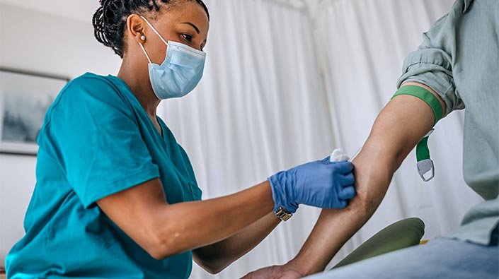 a-phlebotomist-demonstrates-how-to-collect-blood