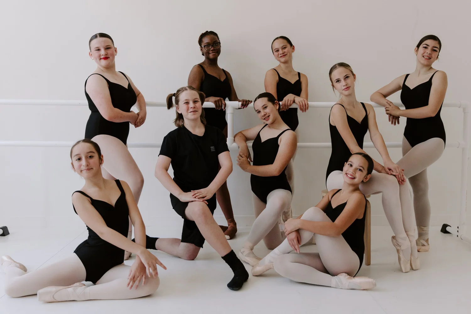 Company 4 dancers posed at the barre