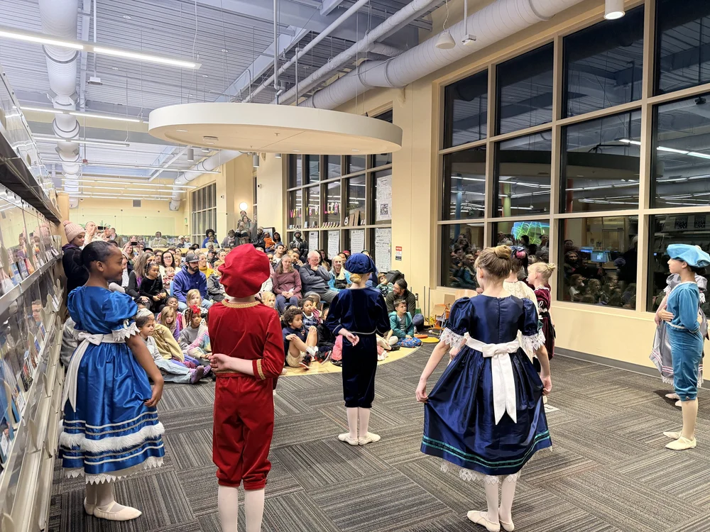 Nutcracker characters performing for families at a community event