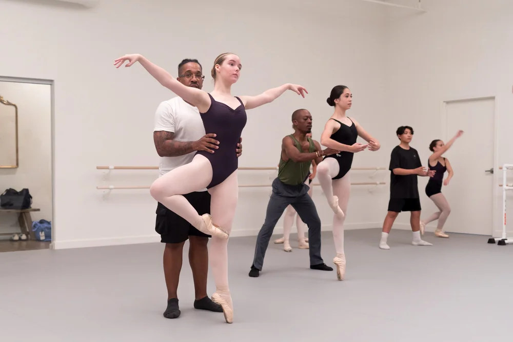 Dancers rehearsing partnering in the studio