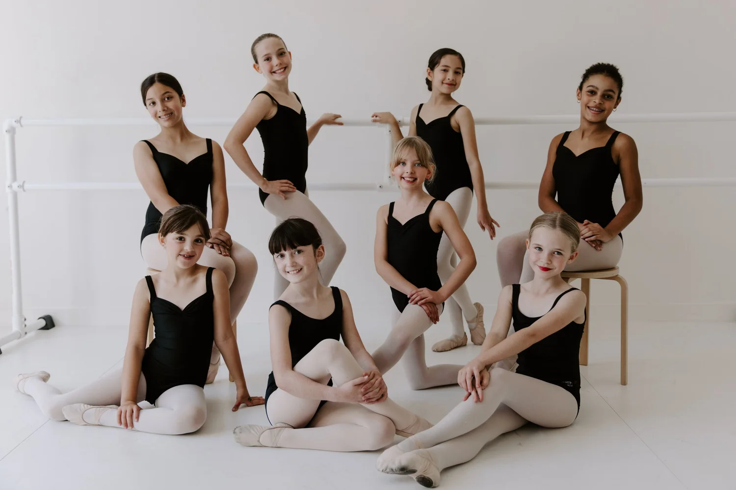 Company 1 dancers posed at the barre