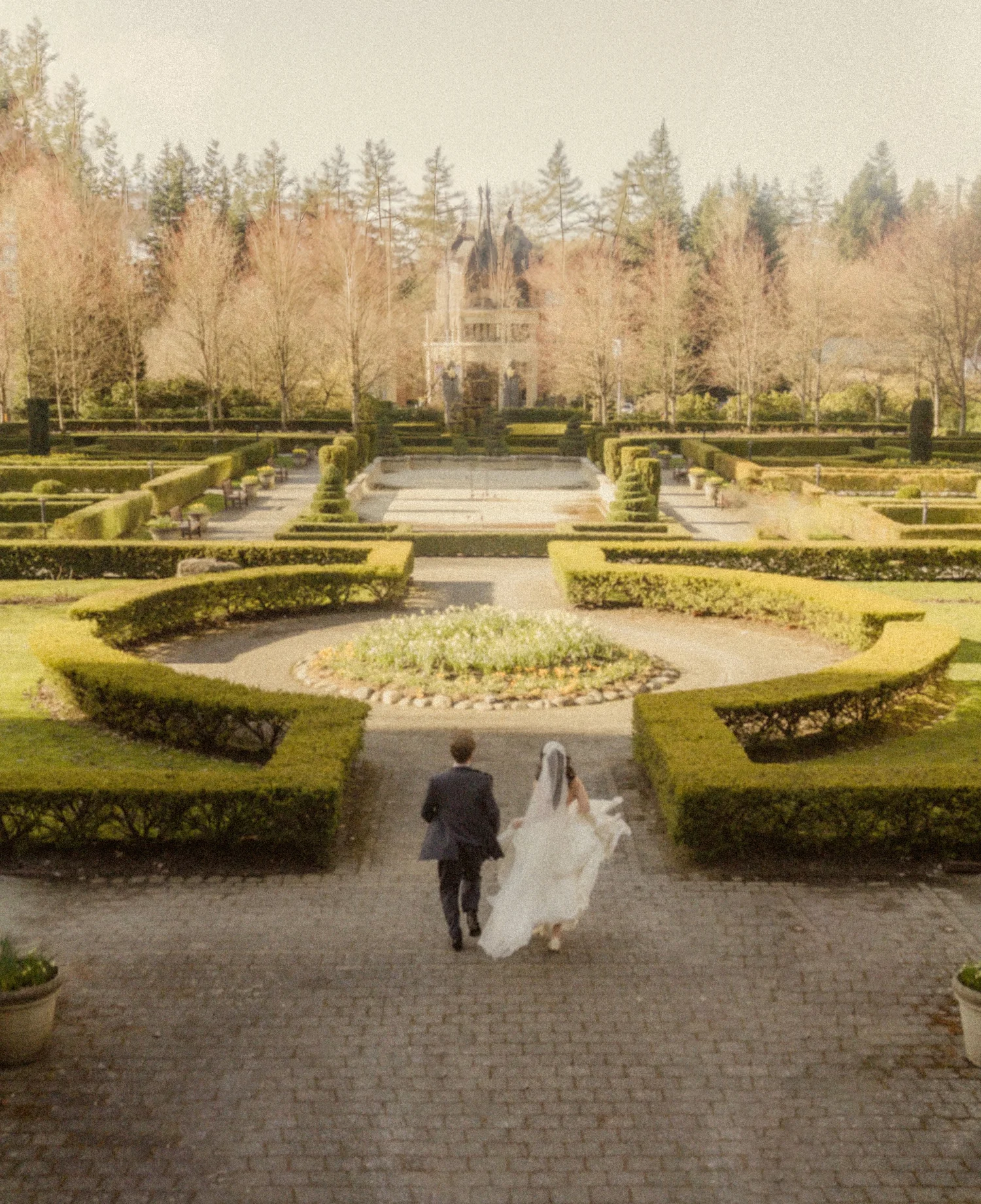 Engaged couple walking through a garden in the Lower Mainland