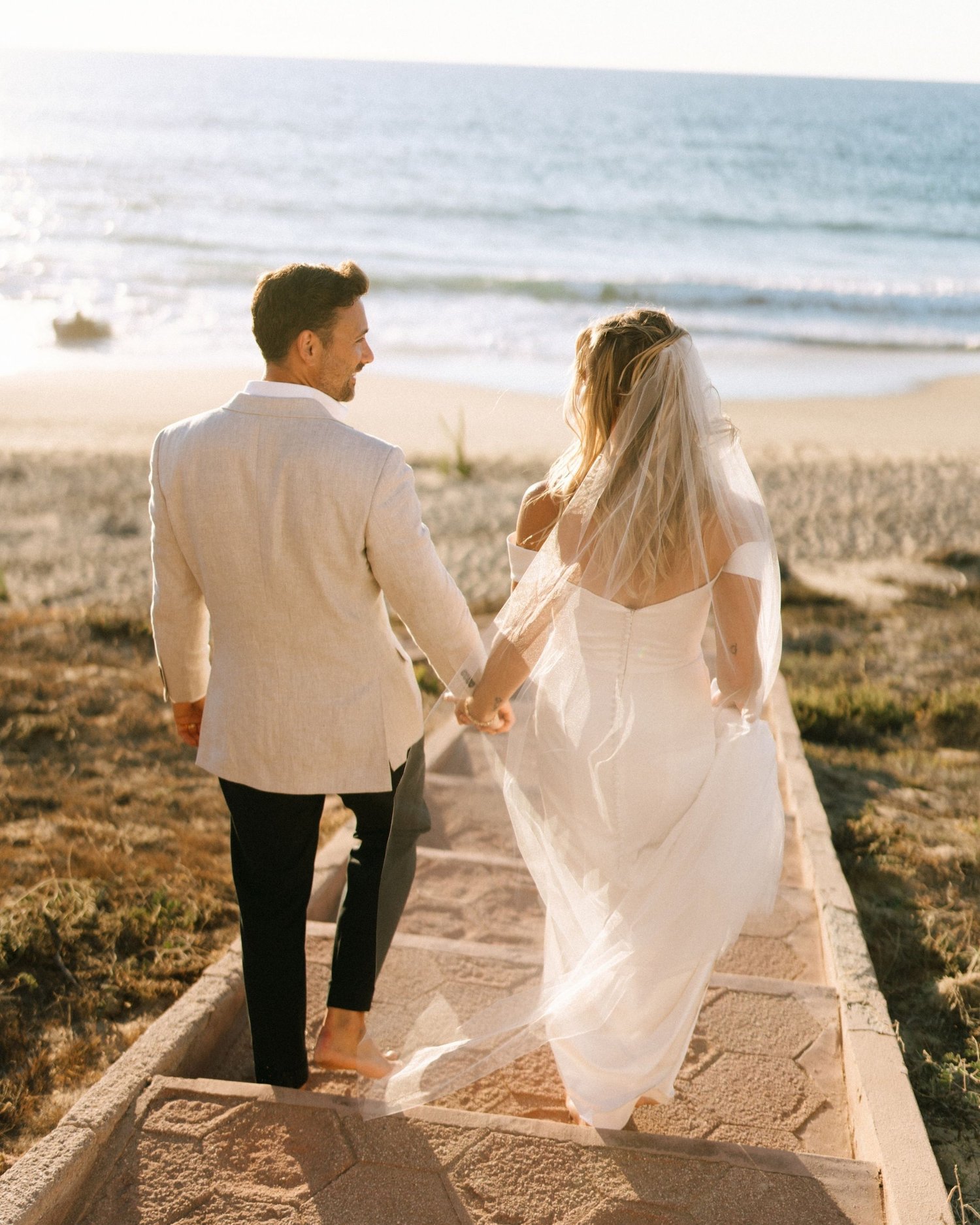 Couple on the beach stairs at sunset, Vancouver Island