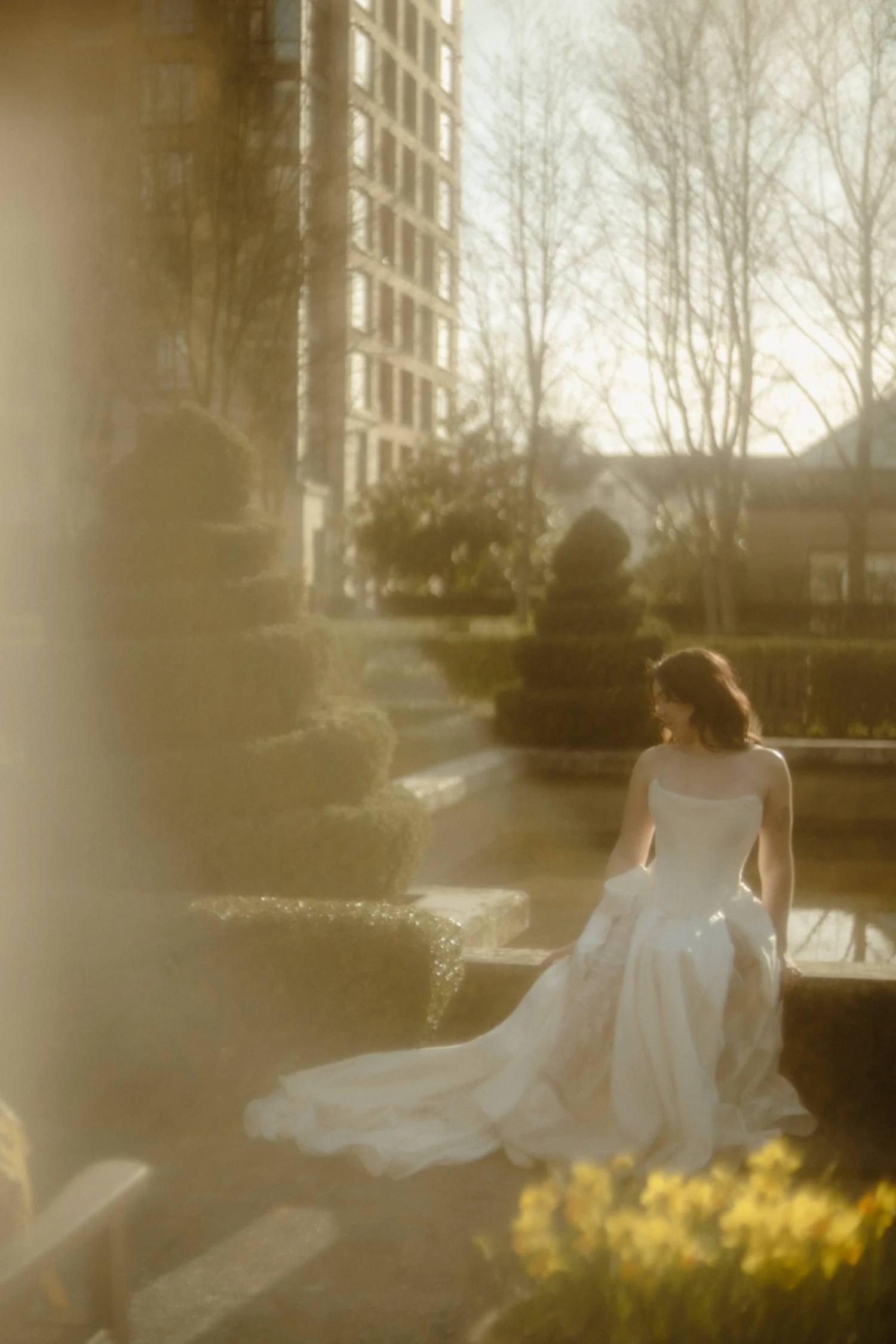 Bride beside a stone fountain before her Vancouver wedding