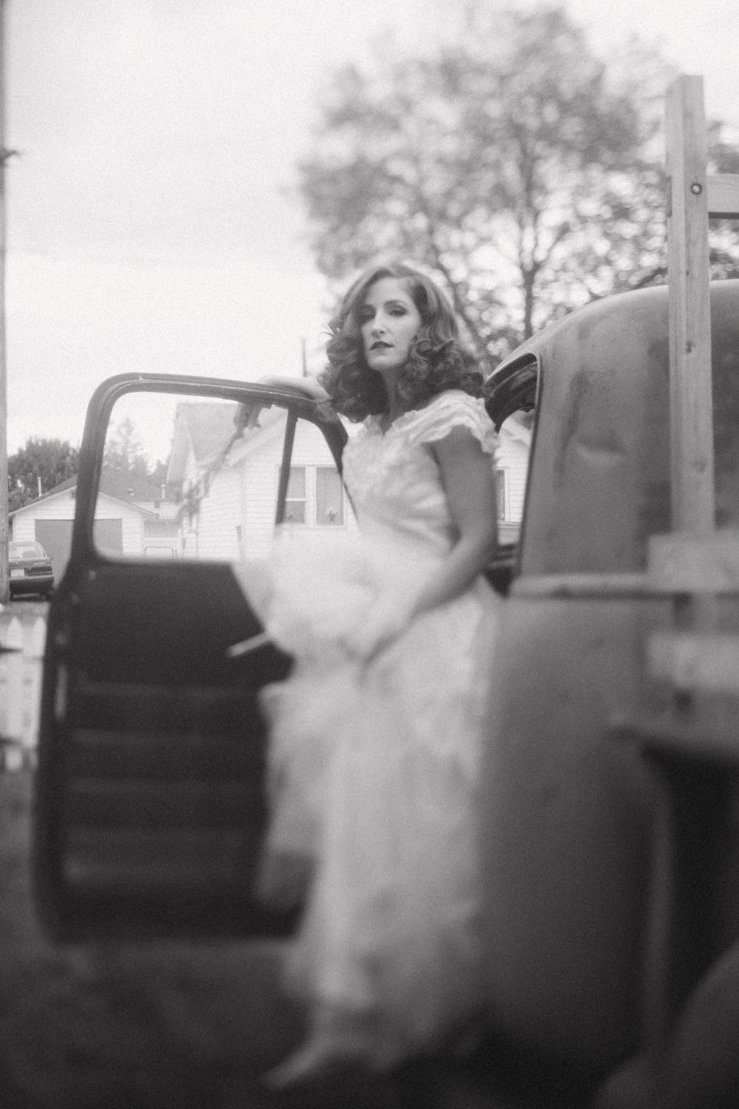 Bride and groom with a vintage truck after their wedding