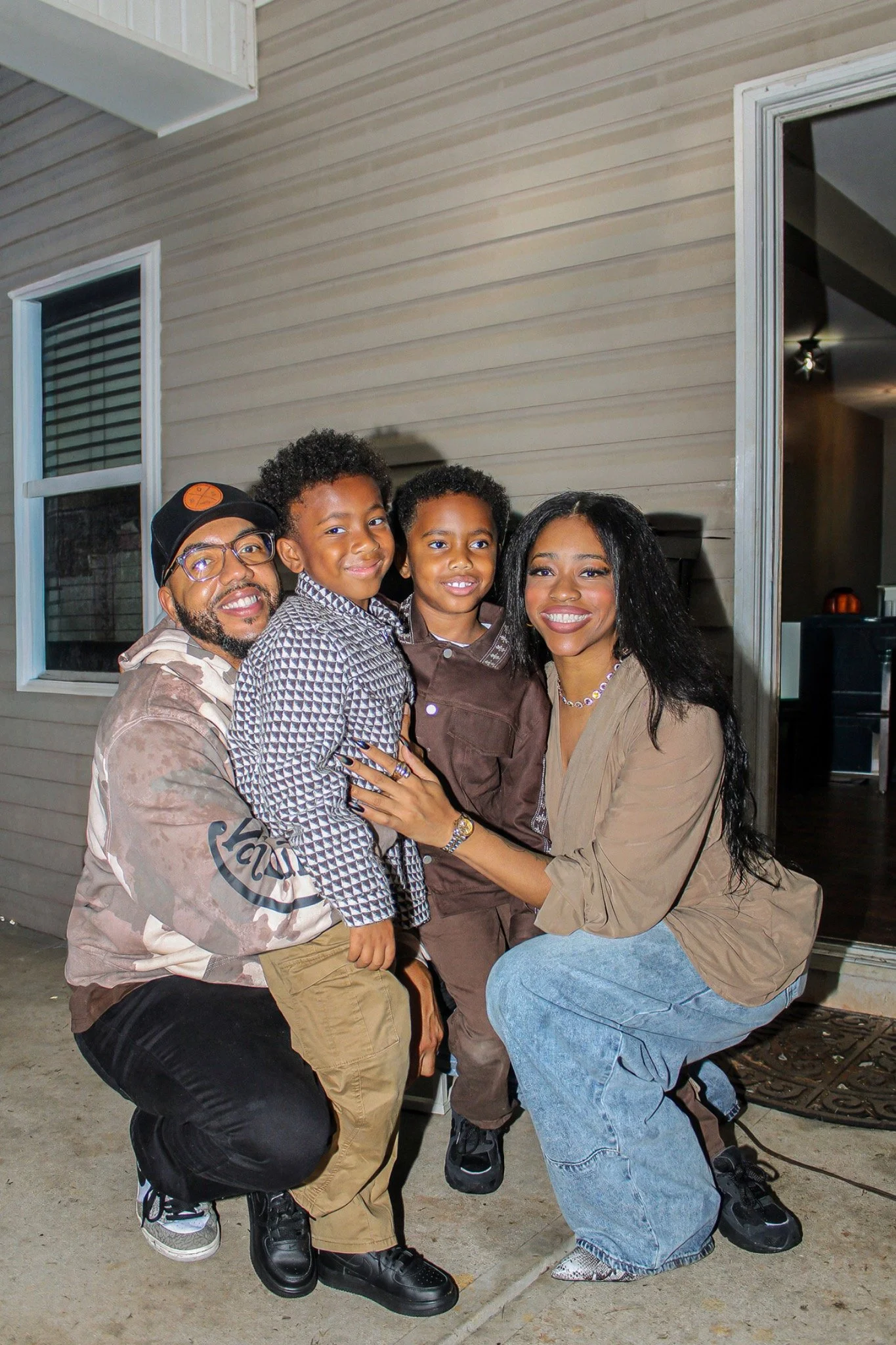 Four guests posing together on the patio