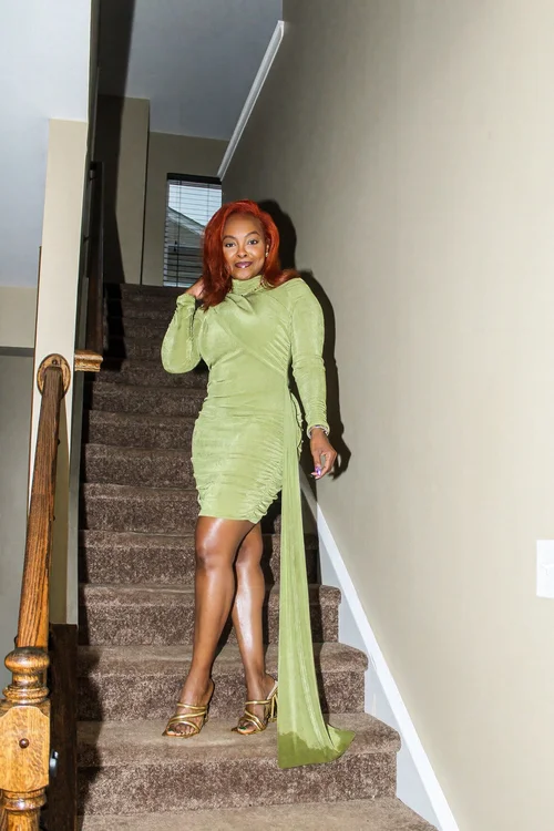 Birthday outfit portrait in a green dress on the stairs