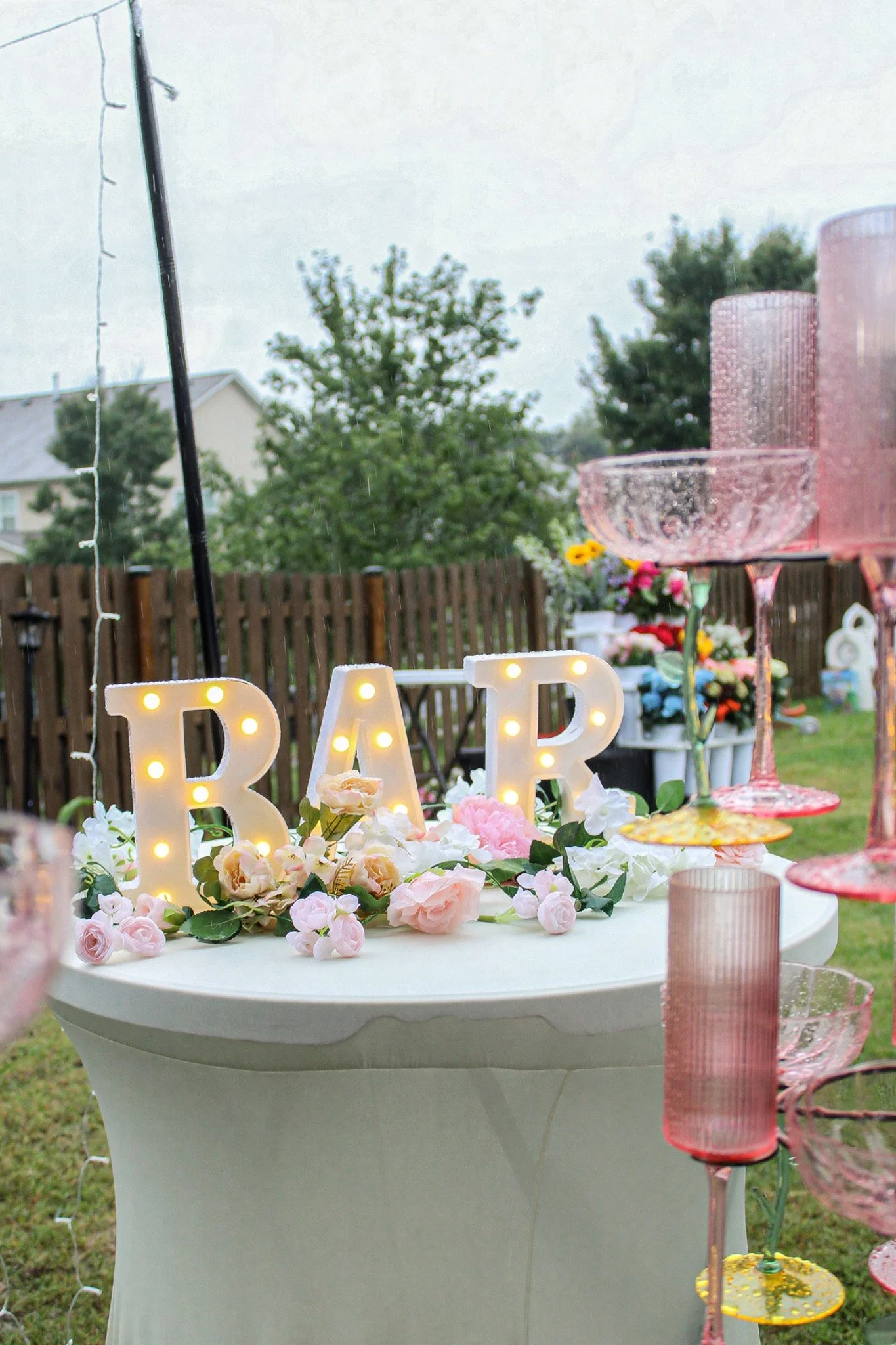 Illuminated BAR letters and blush champagne glasses