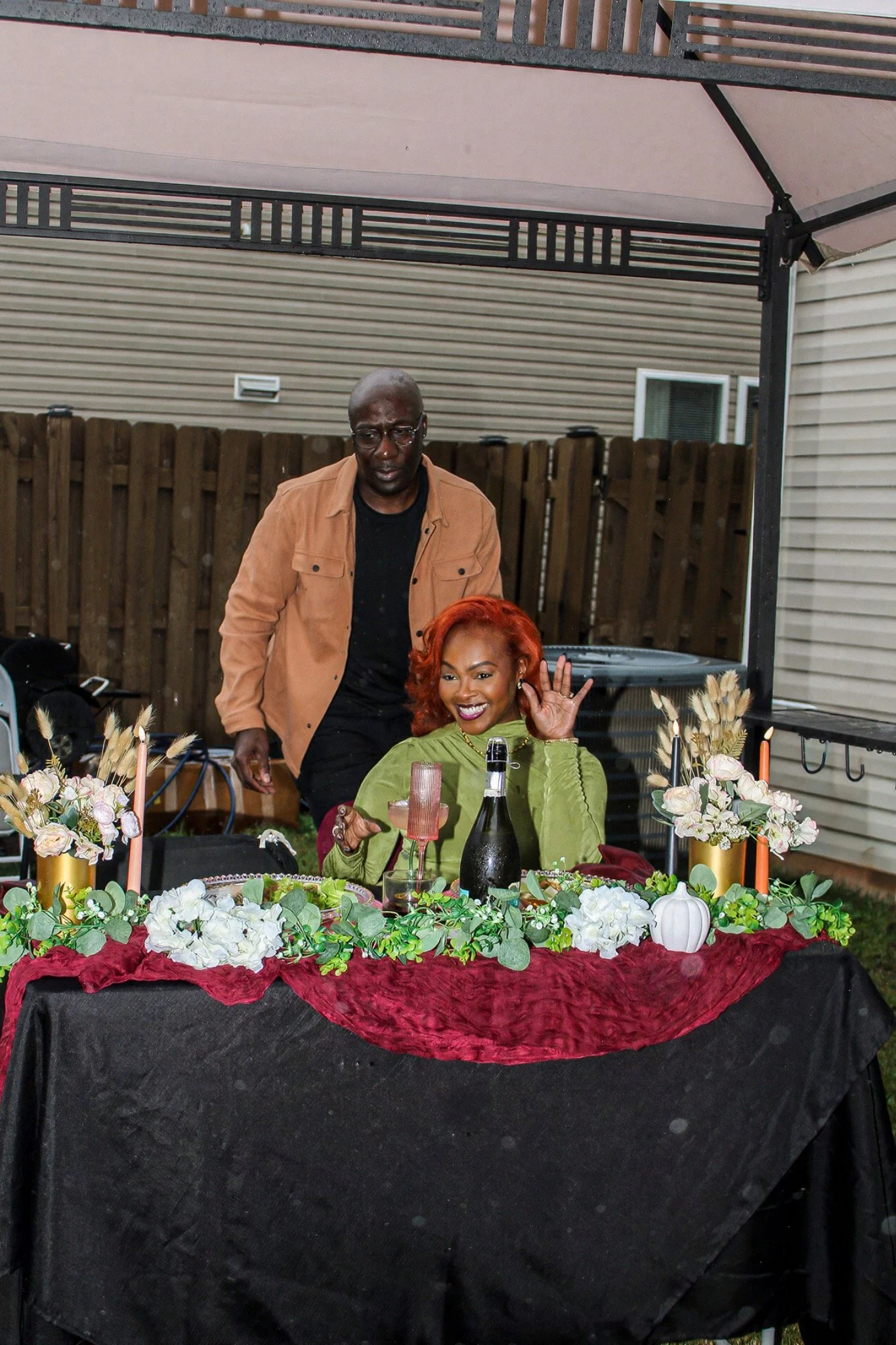 A smiling moment at the flower-lined birthday table