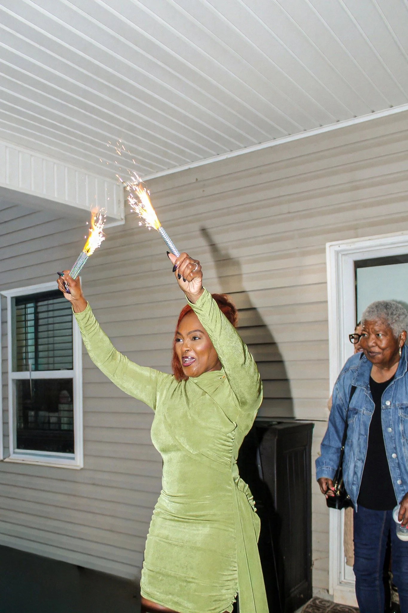 Raising sparklers overhead at the birthday party