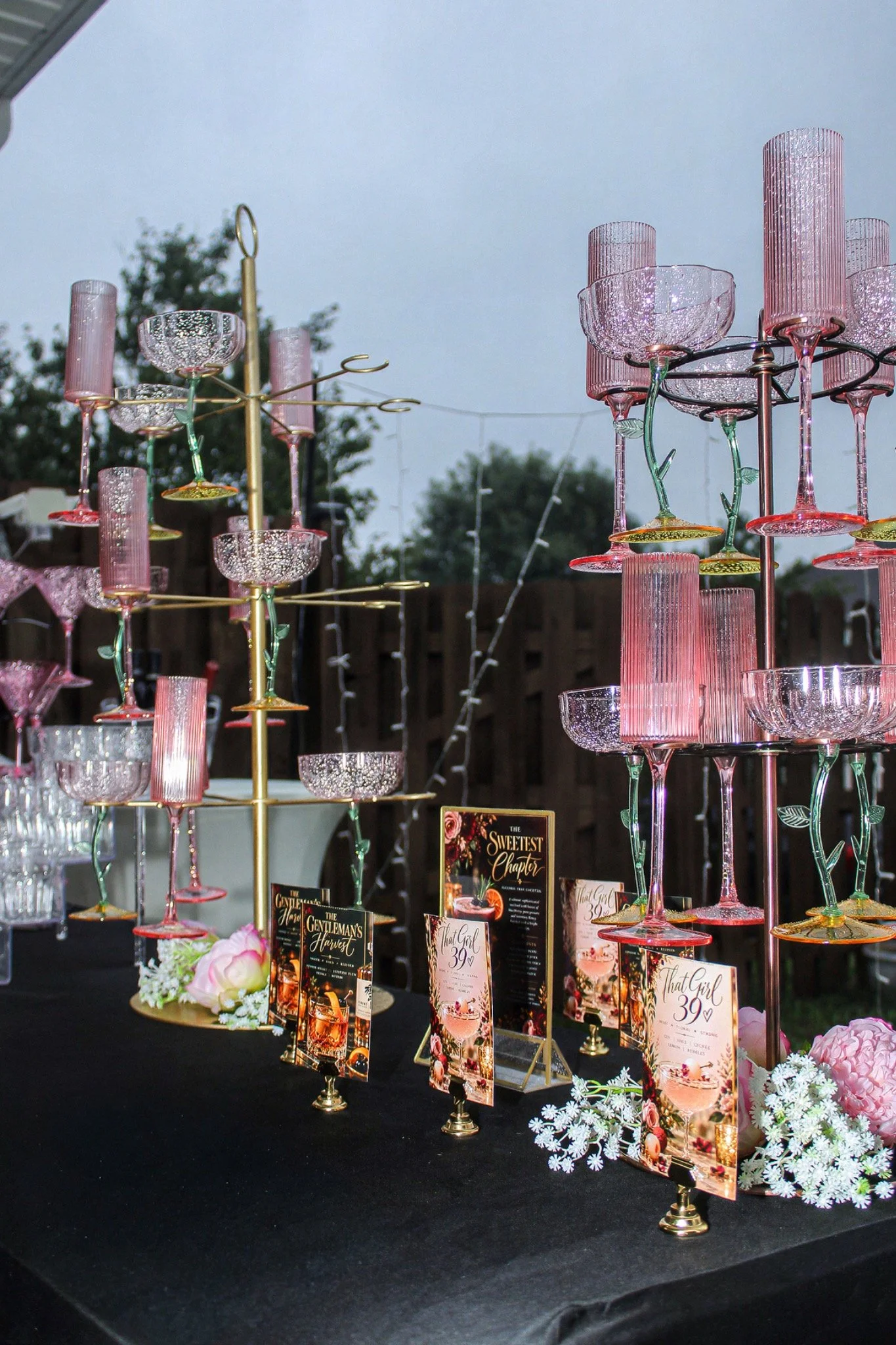 Blush glasses on gold stands at the bar