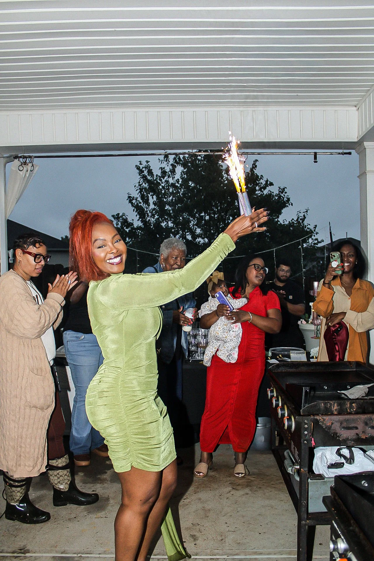 A festive sparkler pose at the birthday gathering