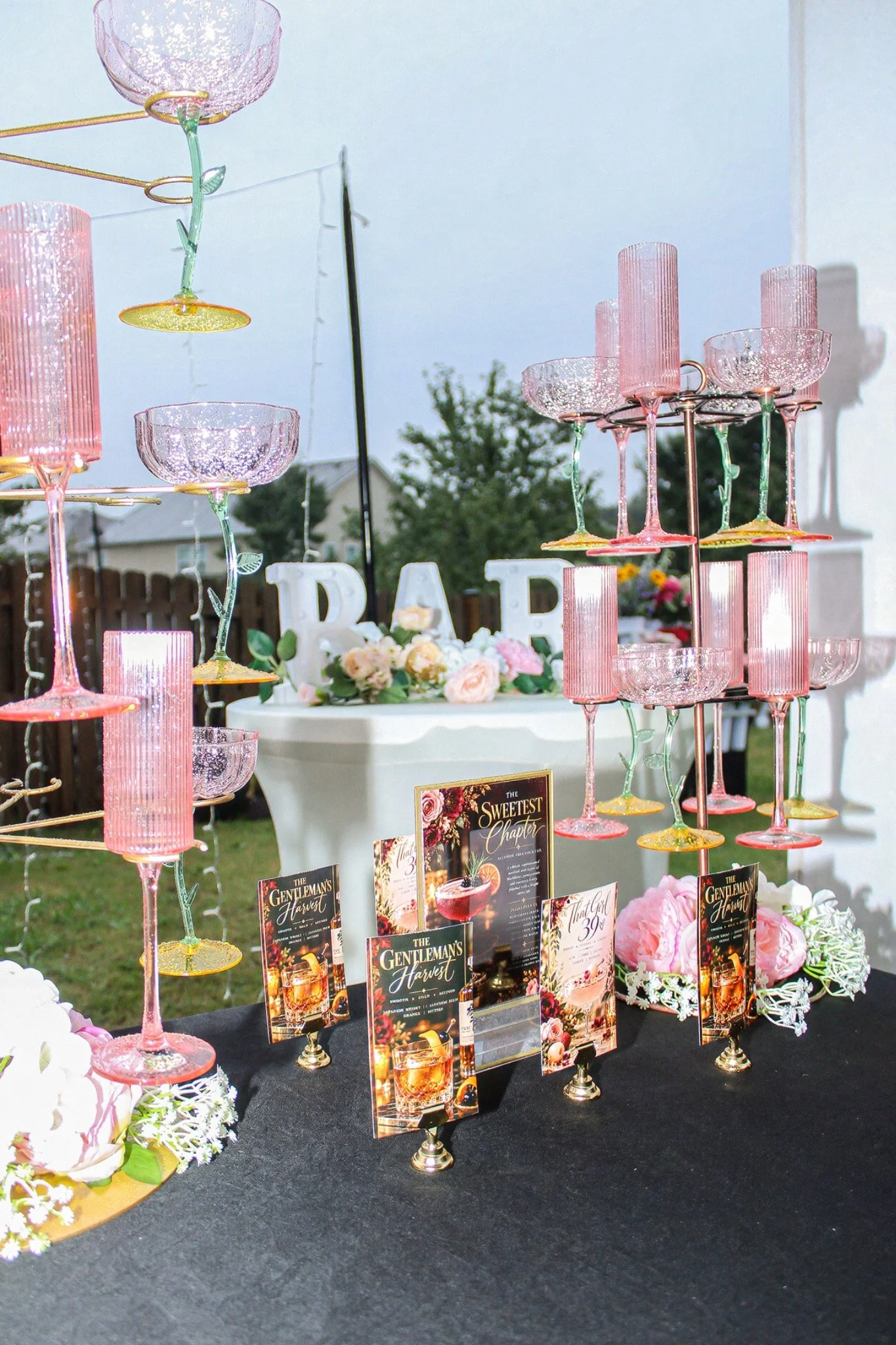 Floral bar display with pink glassware