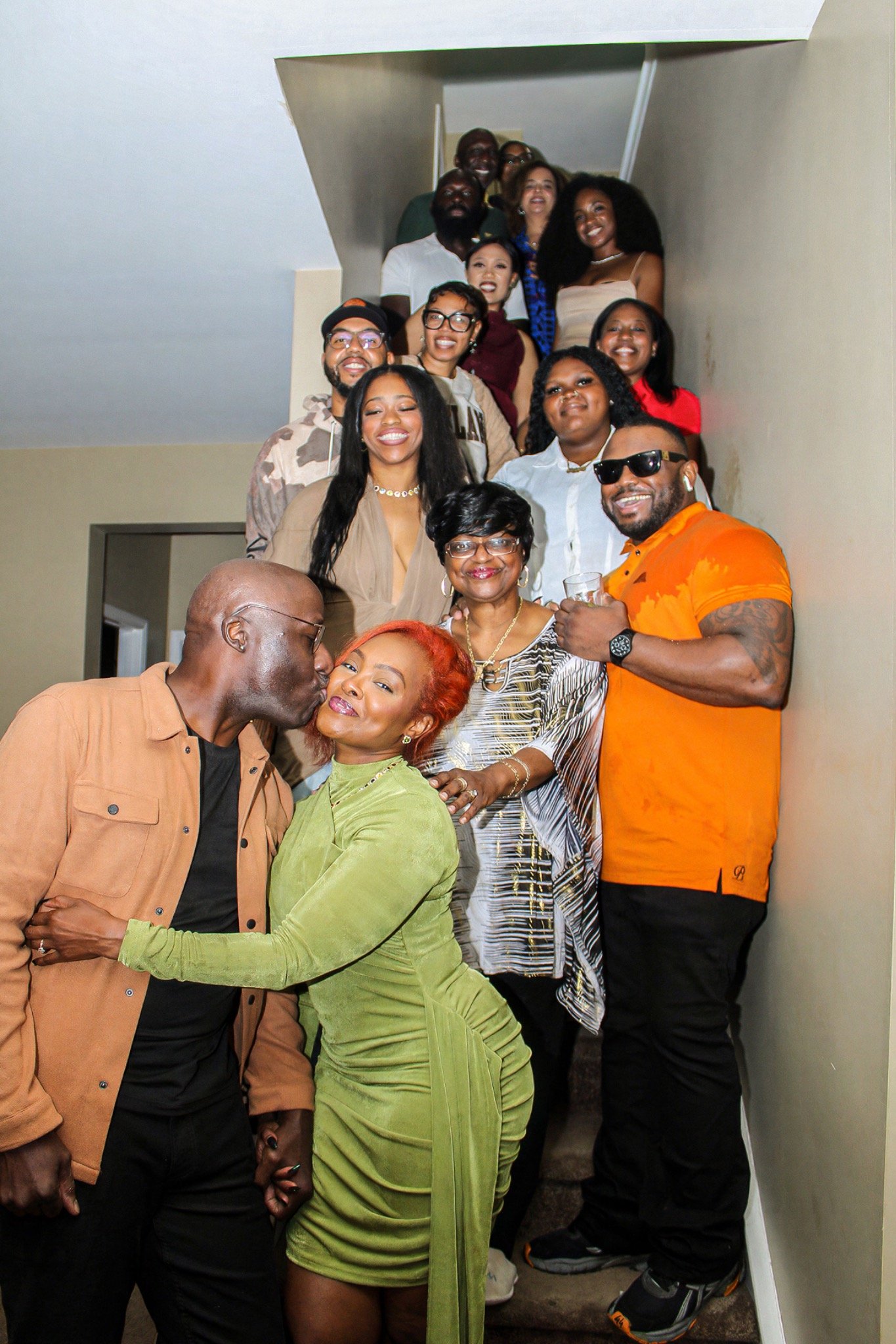 A large birthday group gathered on the staircase