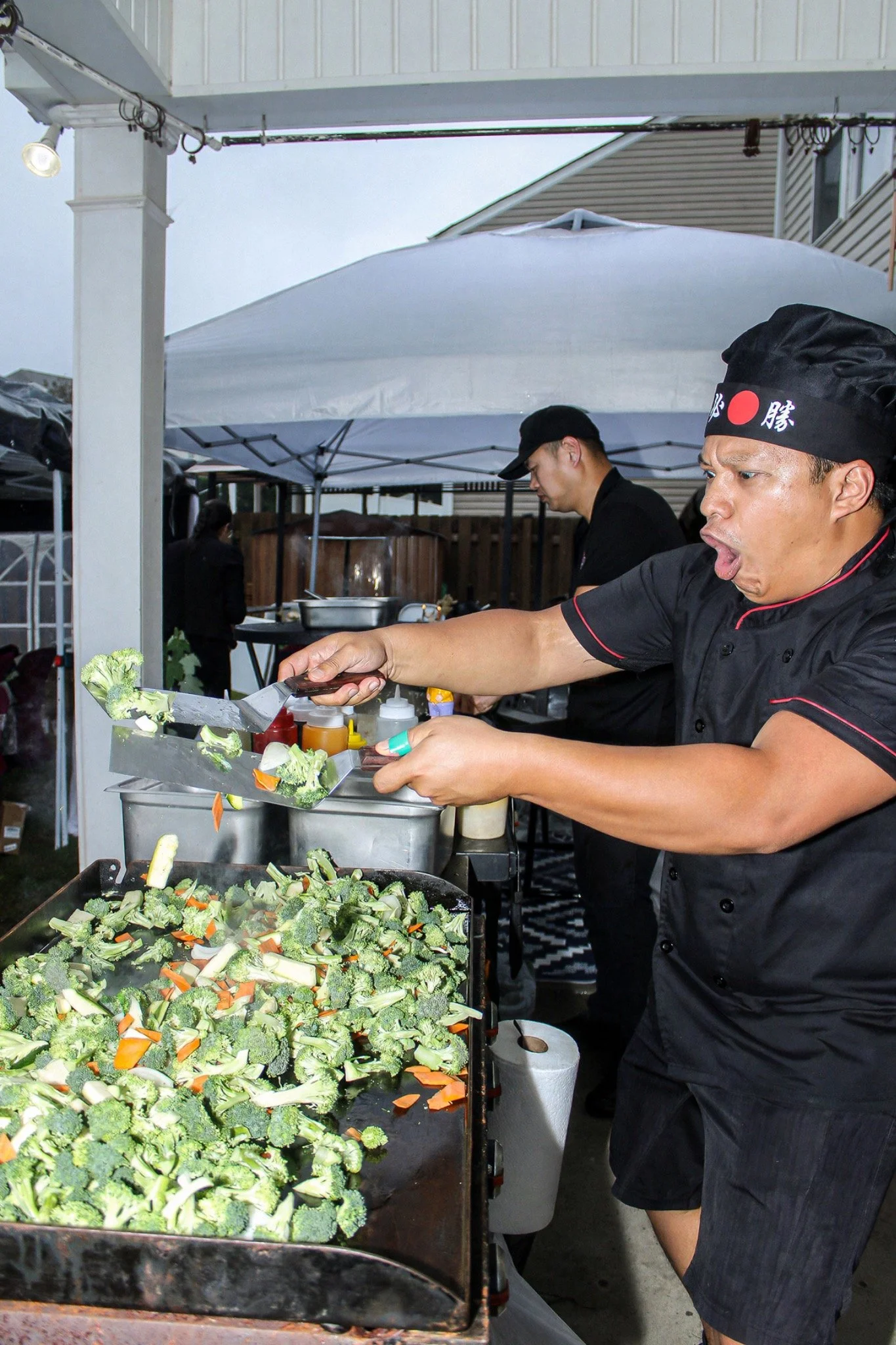 Hibachi chef entertaining guests while cooking