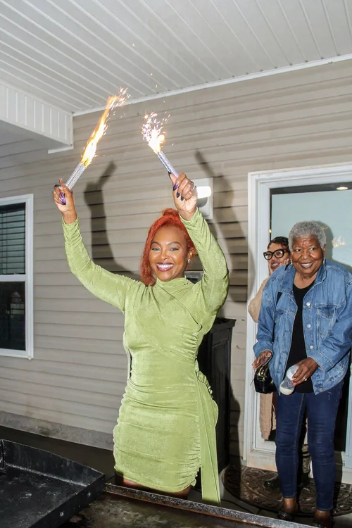 Smiling with sparklers held high