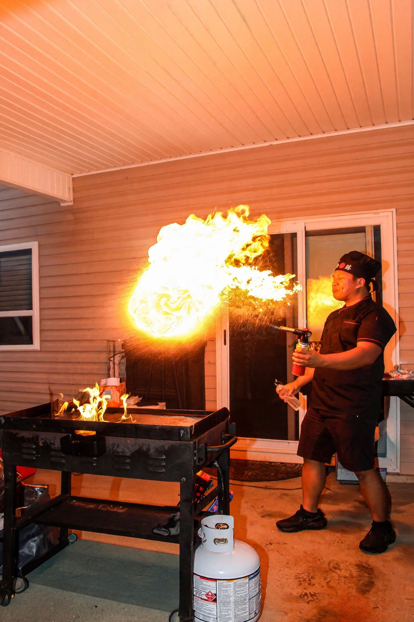 Hibachi chef creating a dramatic fire display