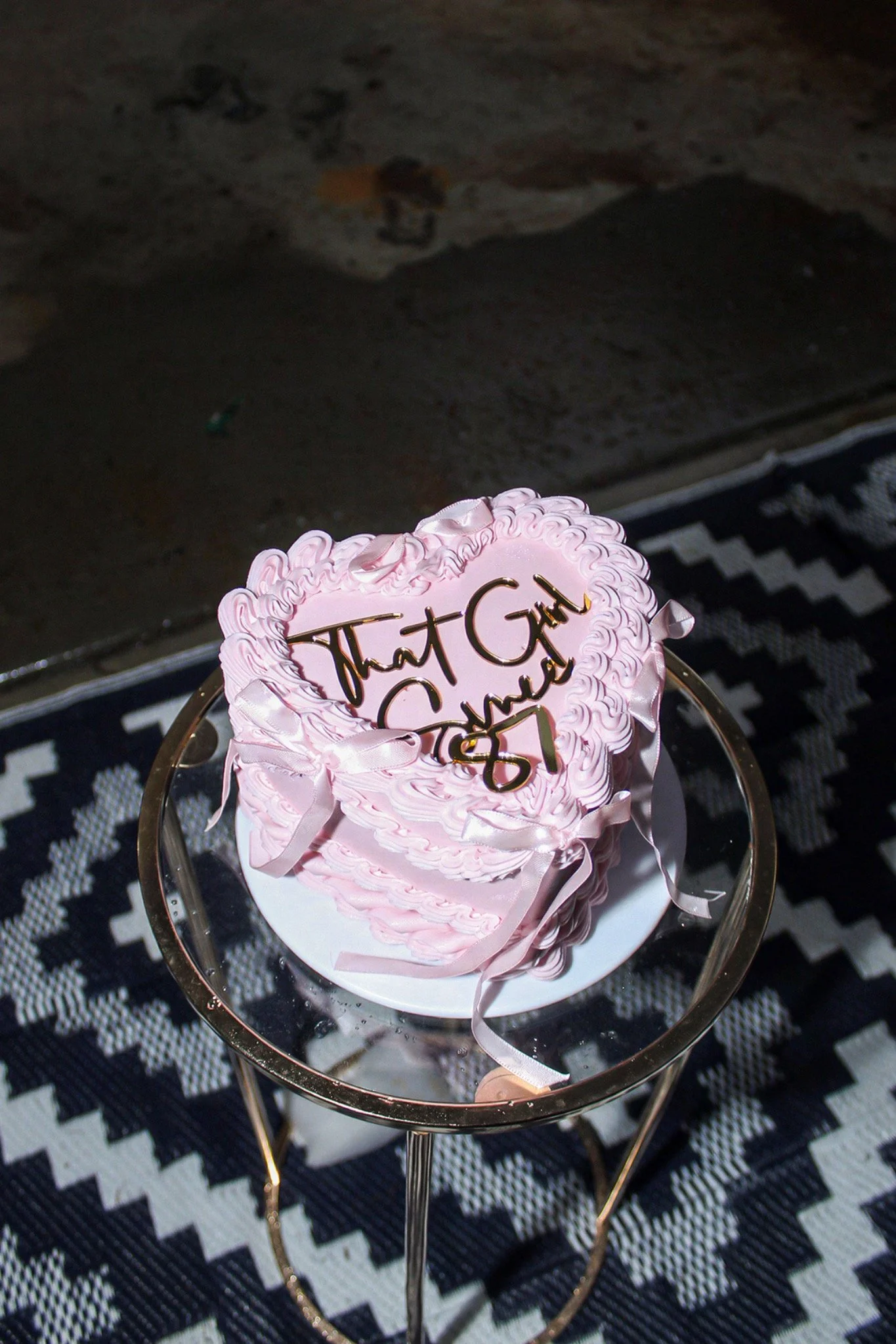 Close-up of the pink birthday cake on its stand
