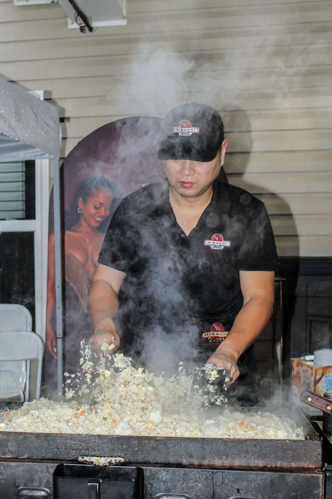 Two hibachi chefs cooking dinner