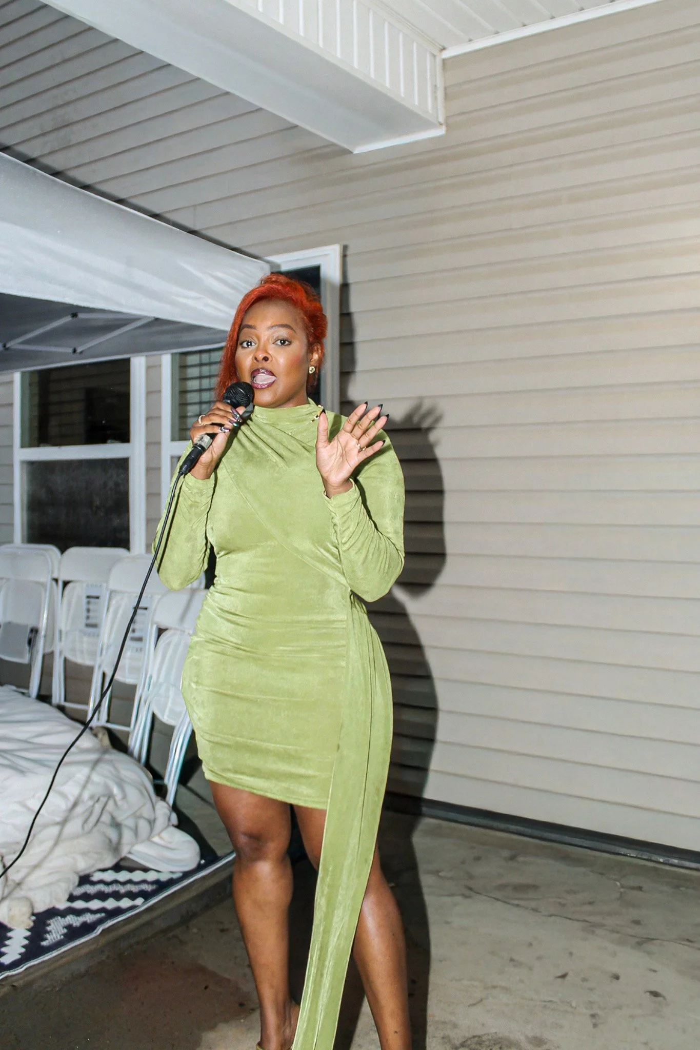 Speaking into a microphone during the birthday celebration