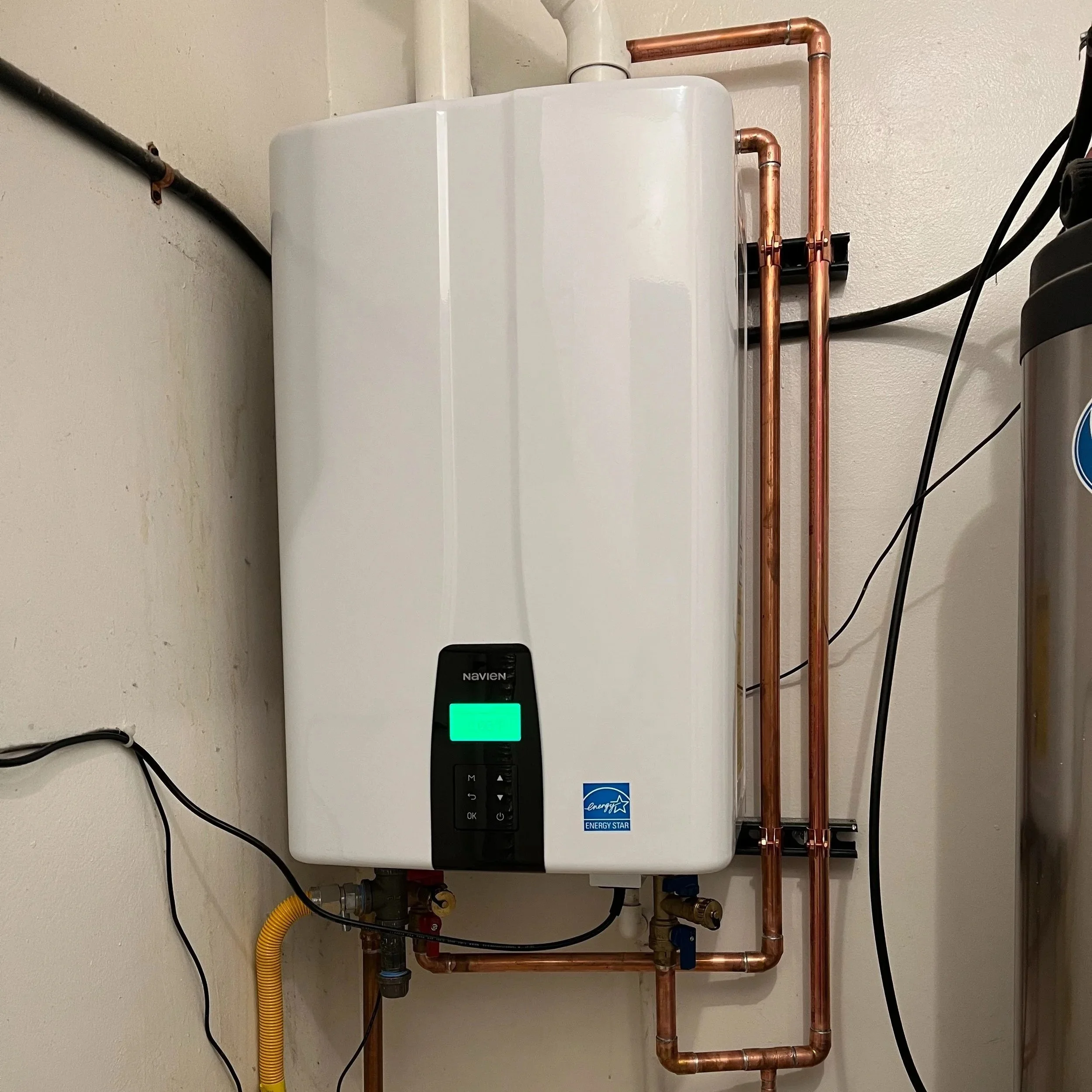 family reviewing tankless water heater specs with plumber