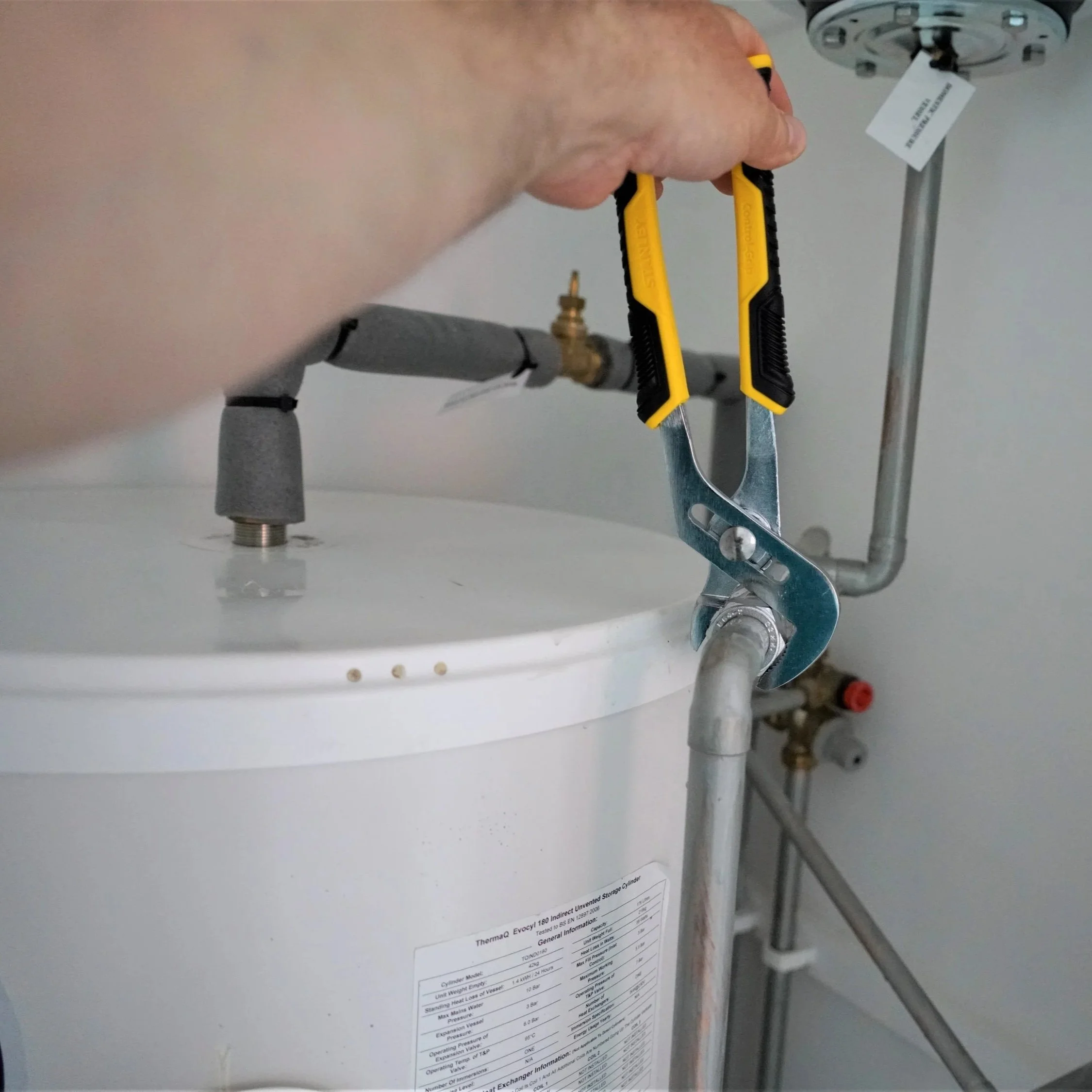 hand gripping a corroded magnesium water heater anode rod