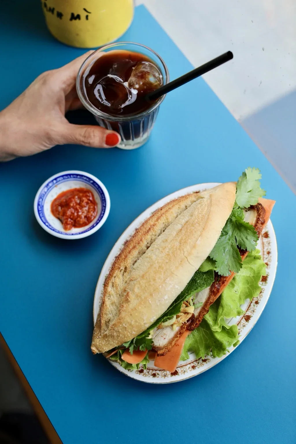 A bánh mì and Vietnamese coffee on our blue table