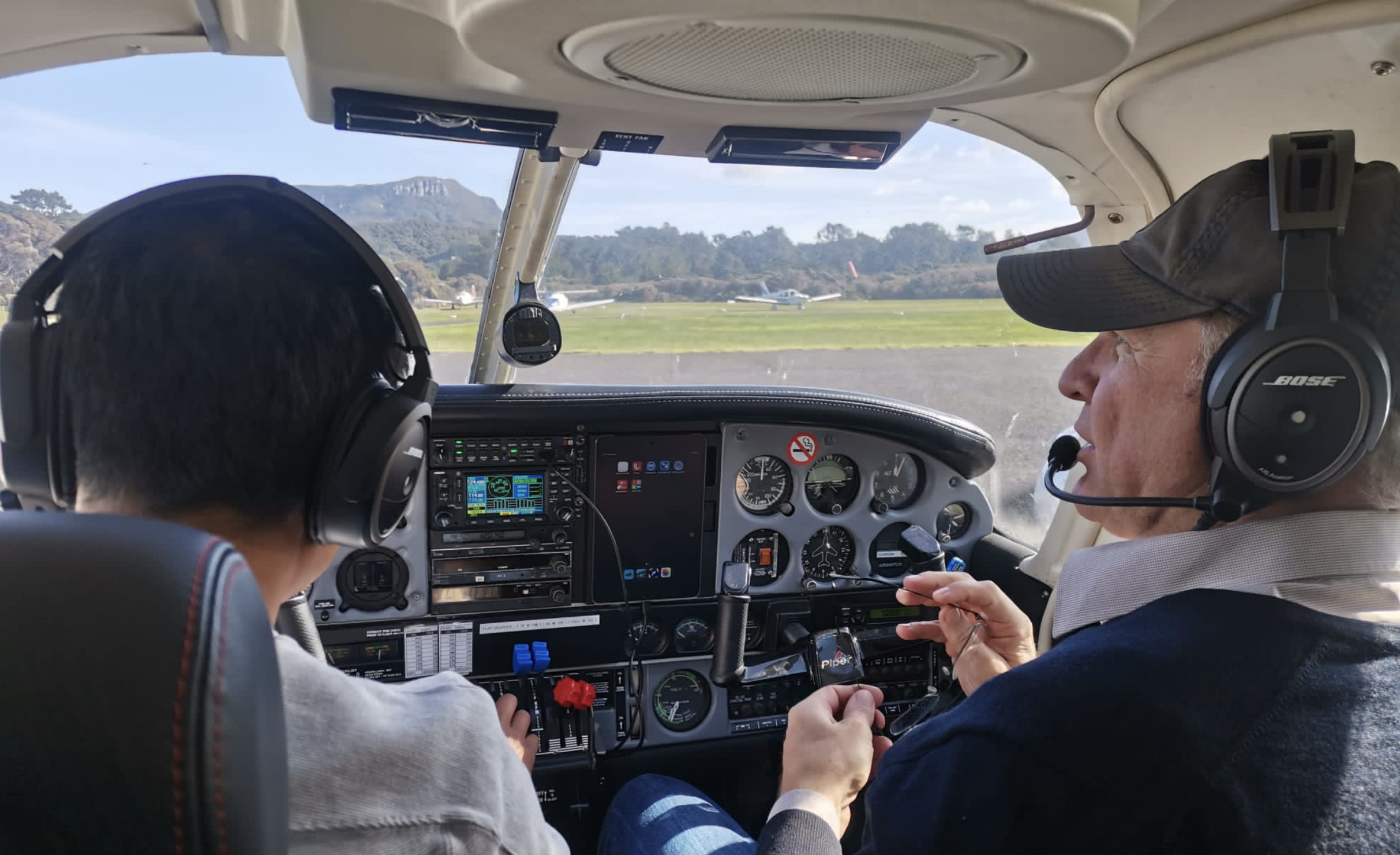 Flight instructor and student in Piper cockpit
