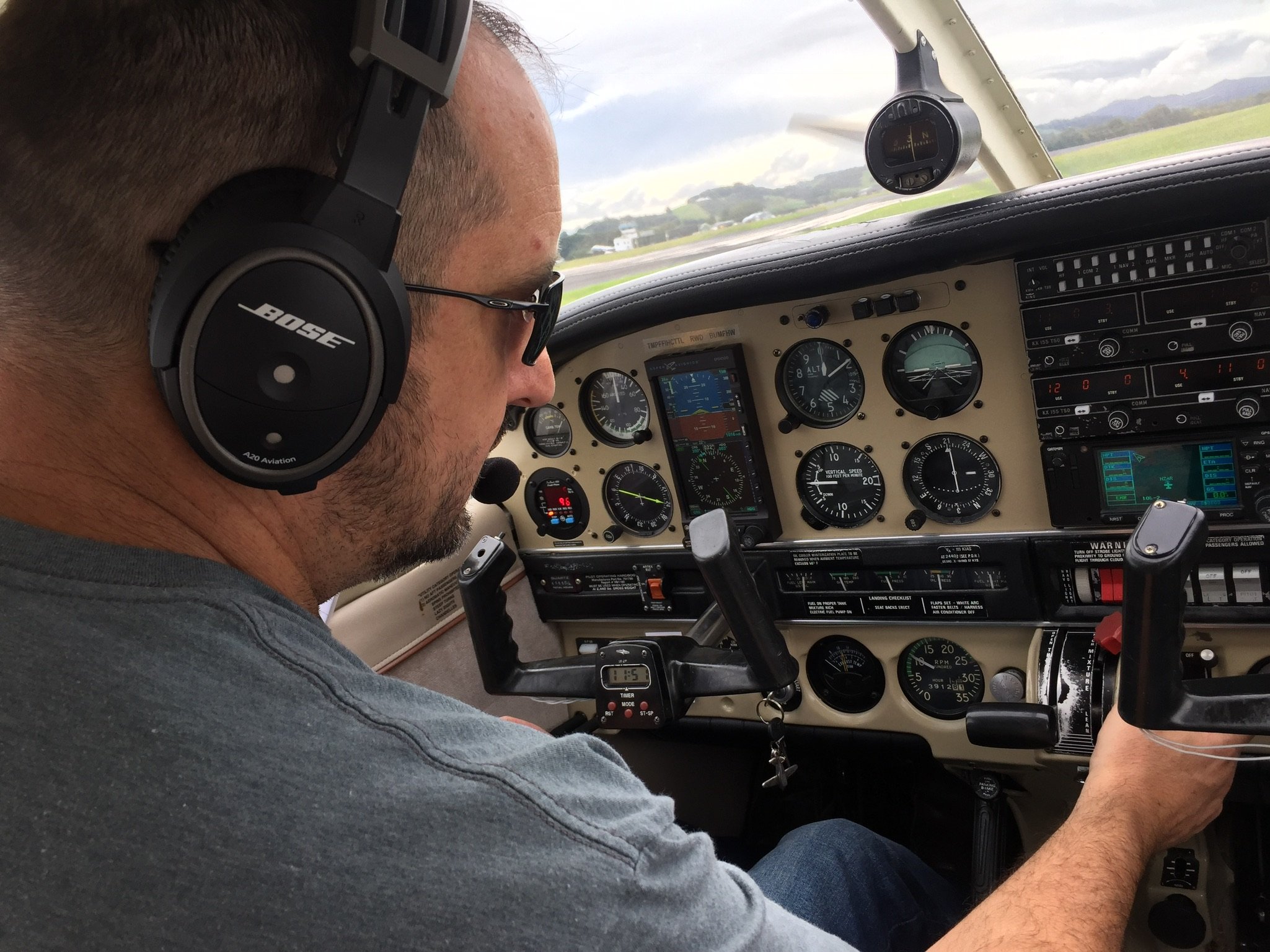 Pilot wearing Bose headset in Cessna cockpit