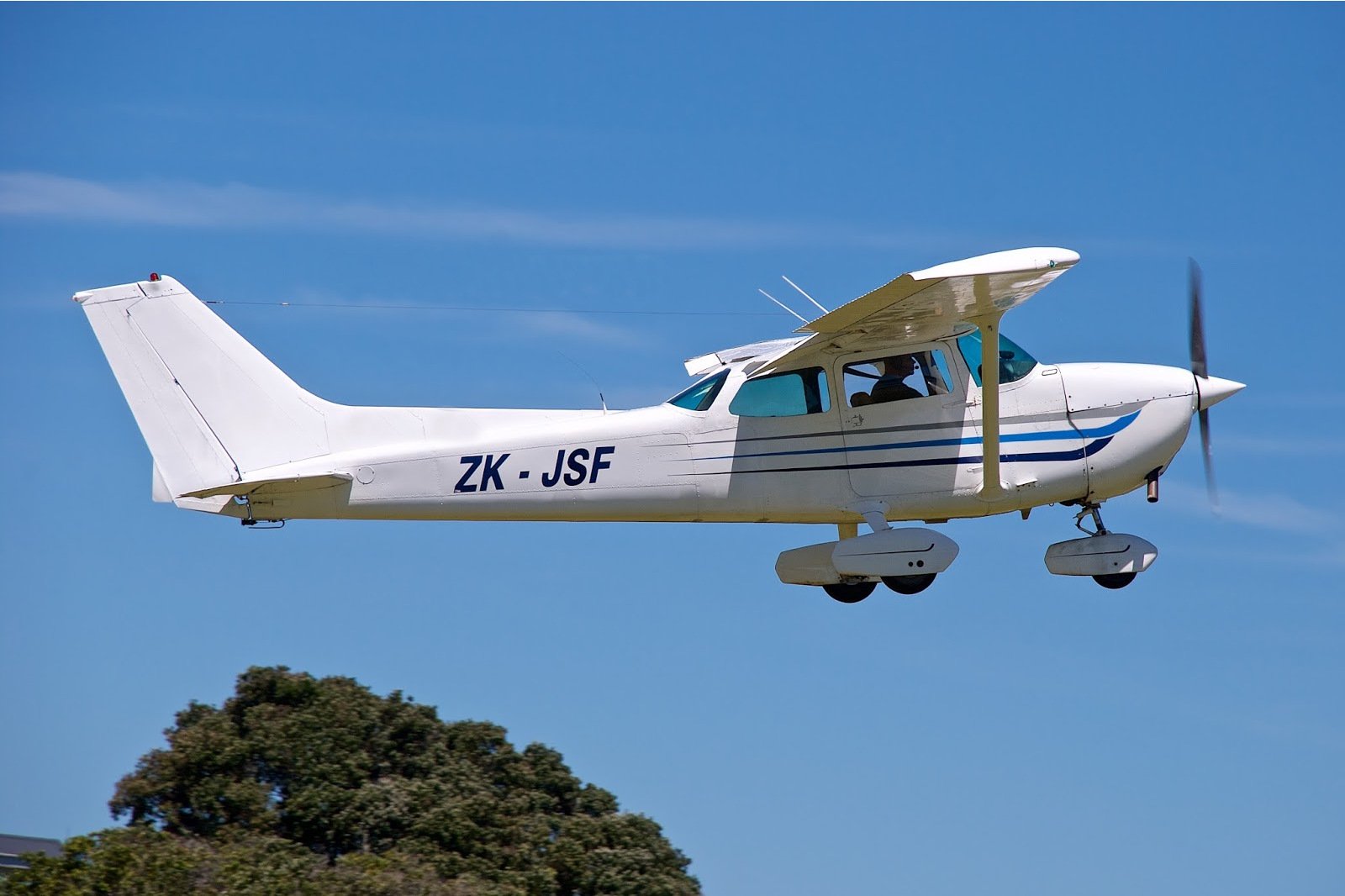 Cessna 172 ZK-JSF flying in blue sky