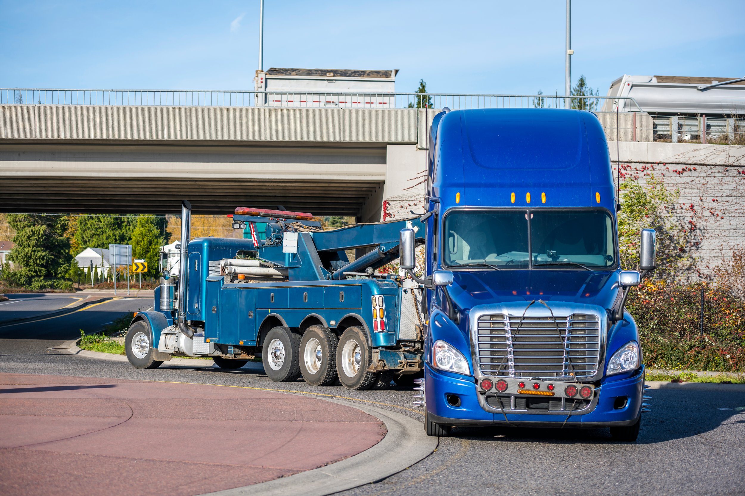 Rollback tow truck transporting a vehicle