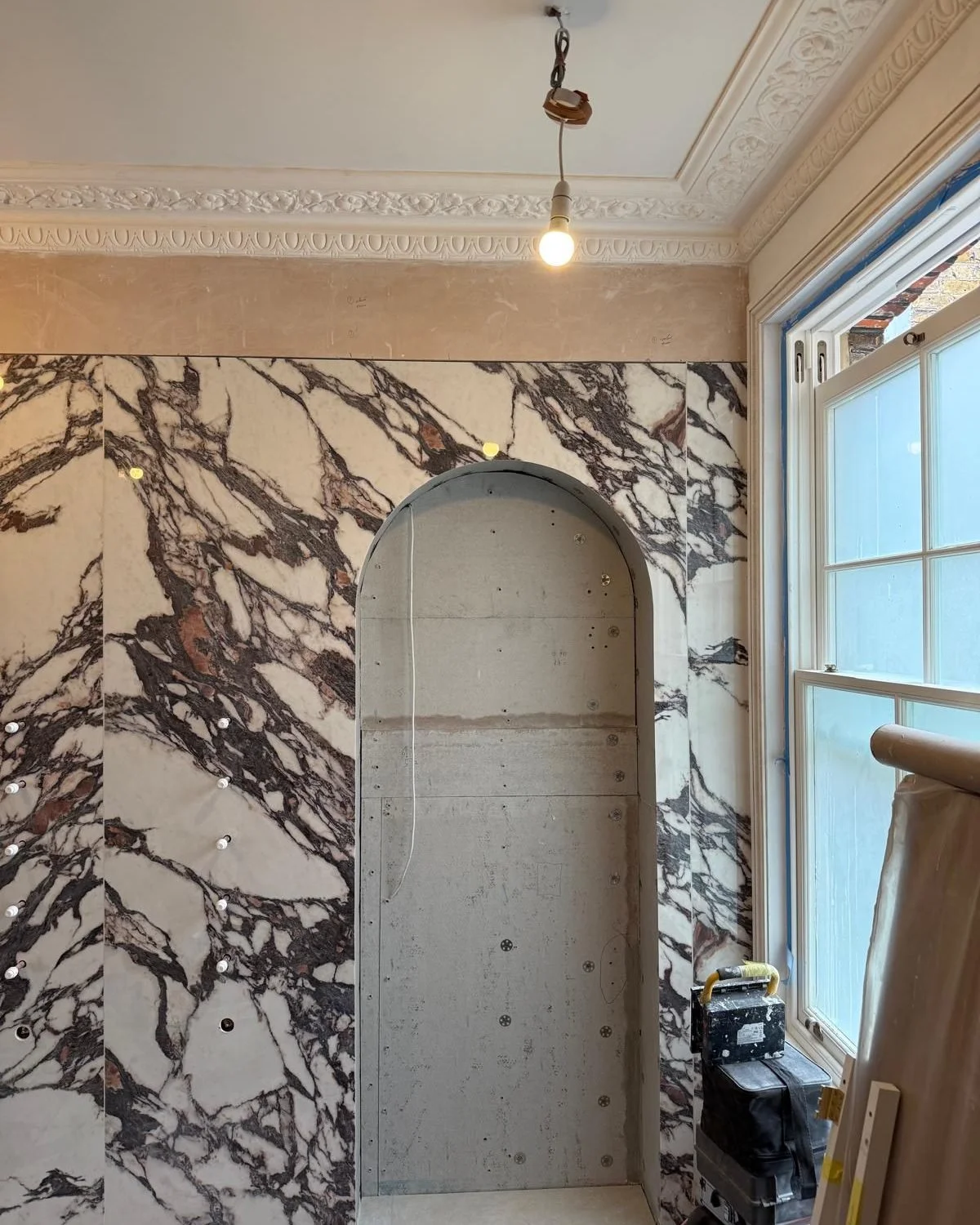 Mayford Road — marble bathroom with an arched niche