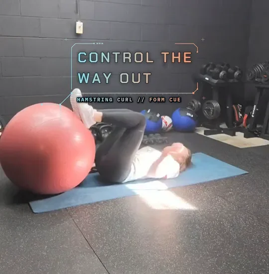 Coach Tabitha lying on a mat with her heels on a stability ball, hips lifted, hips up