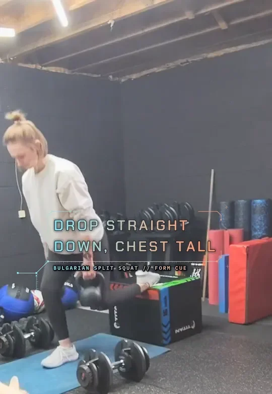 Coach Tabitha in a Bulgarian split squat with her rear foot on a plyo box, holding kettlebells, top: rear foot on the box