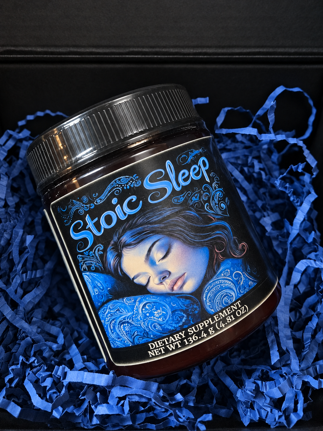 Stoic Sleep jar packed in its black shipping box with blue paper filling