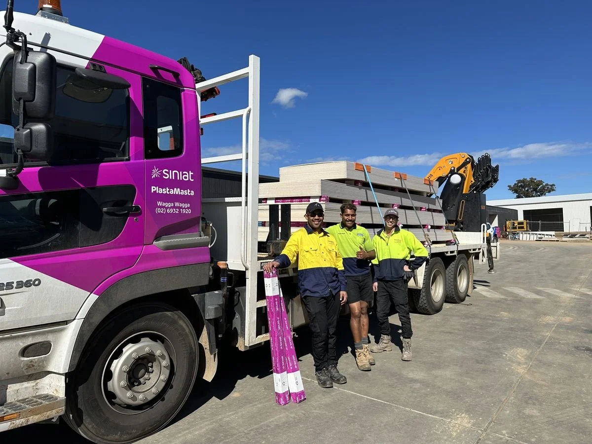 The PlastaMasta Wagga delivery crew with a loaded Siniat crane truck