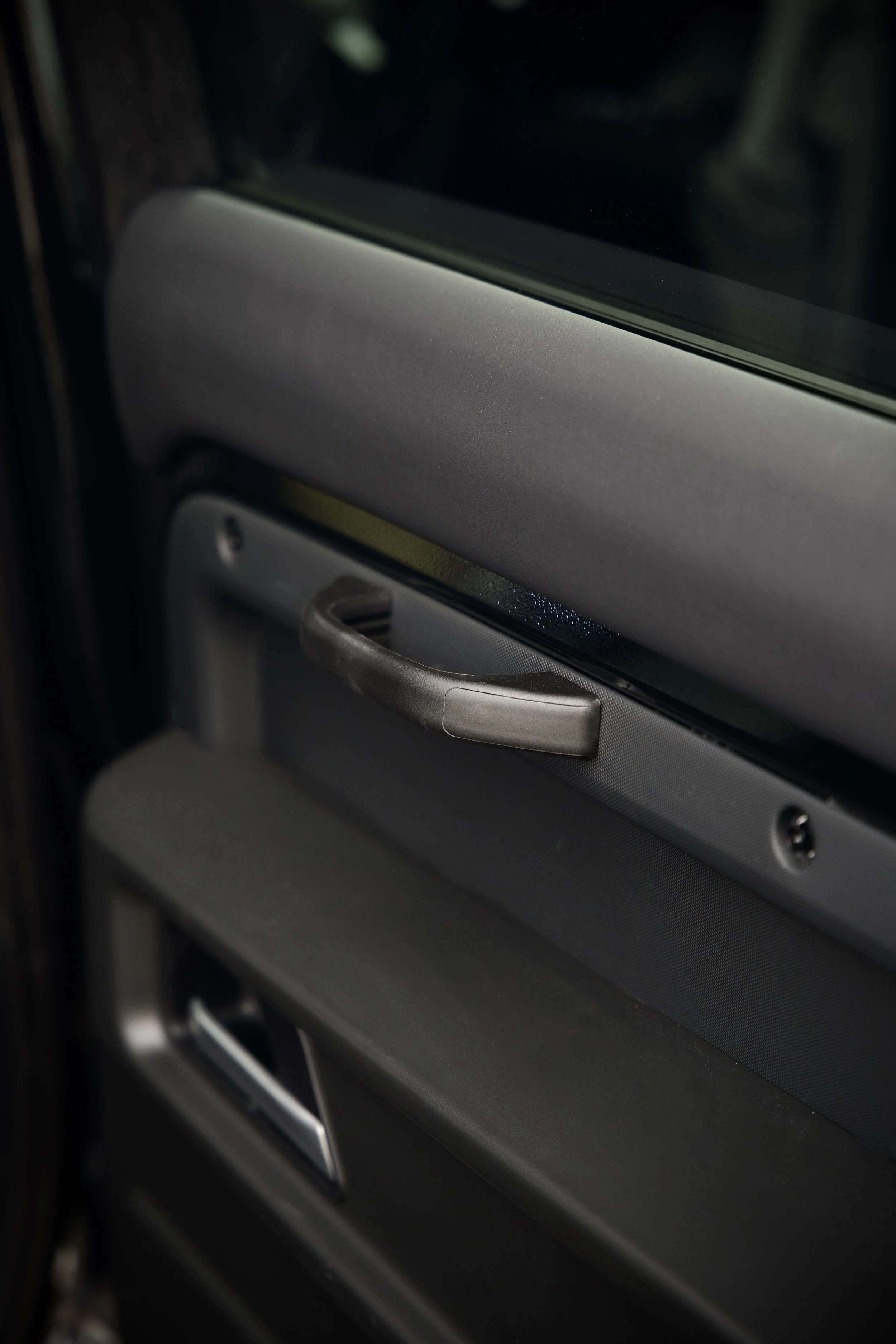 Defender 110 genuine Land Rover door handles and Alcantara trim fitted by Utopia Tints