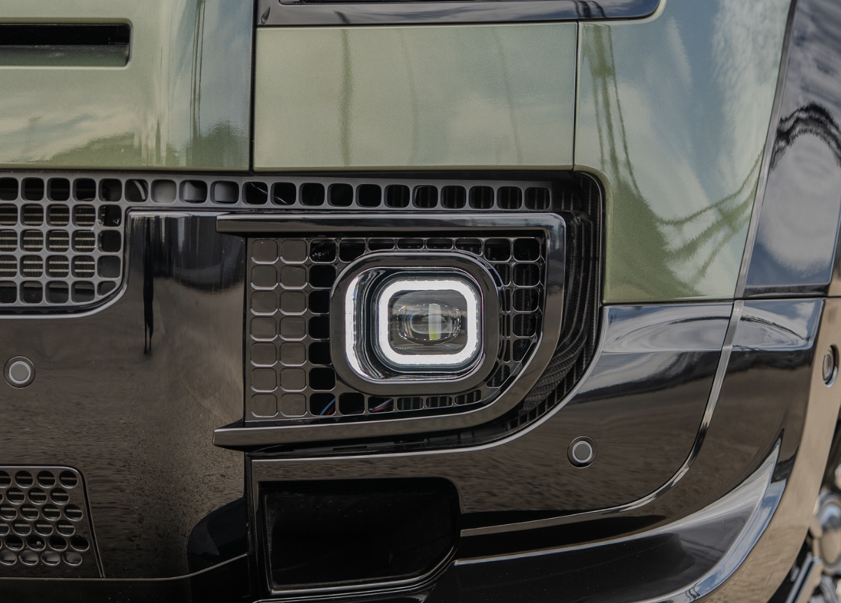 Gloss black vented fog light with square DRL signature on a Land Rover Defender