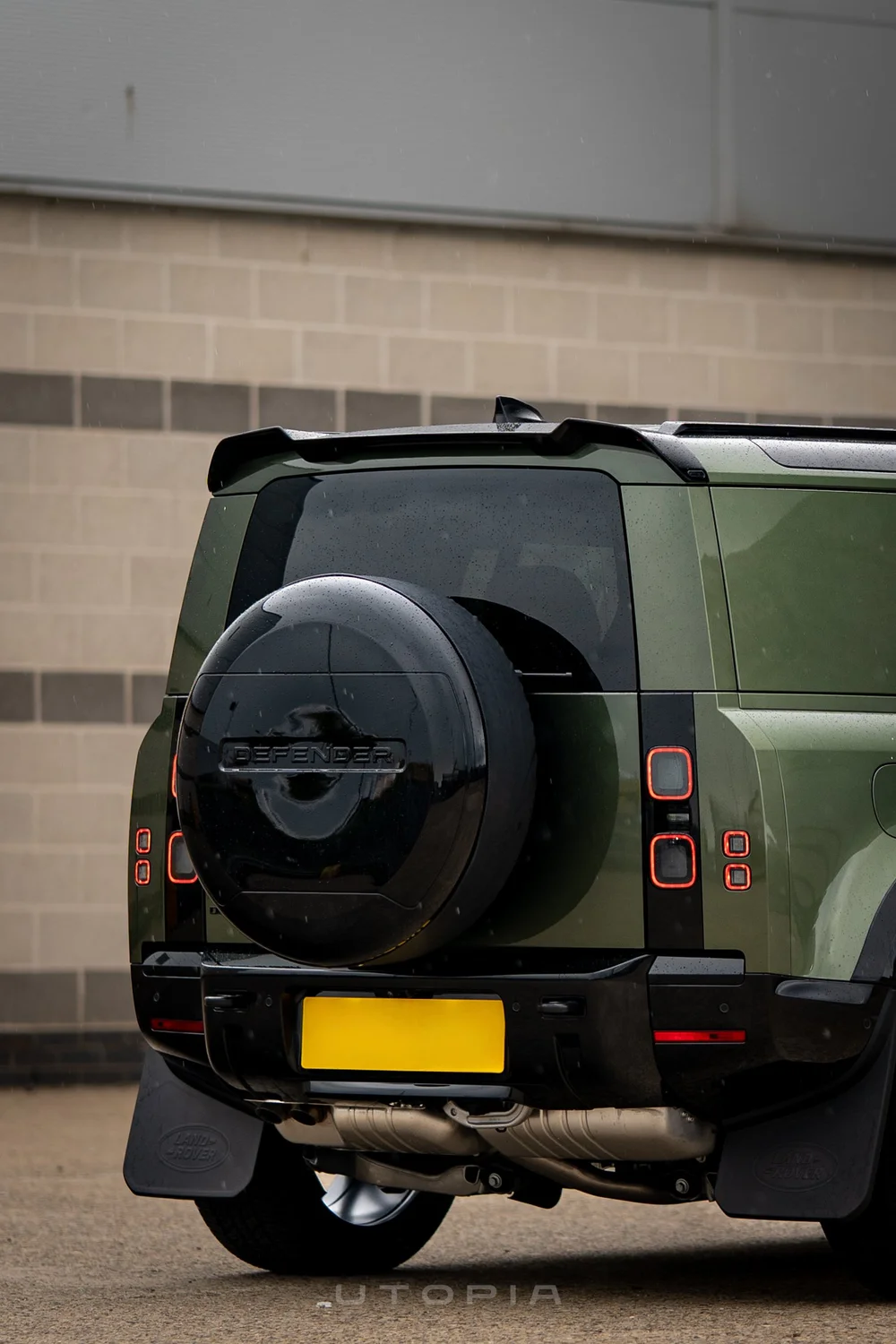 Gloss black stick-on rear spoiler V1 on Defender tailgate